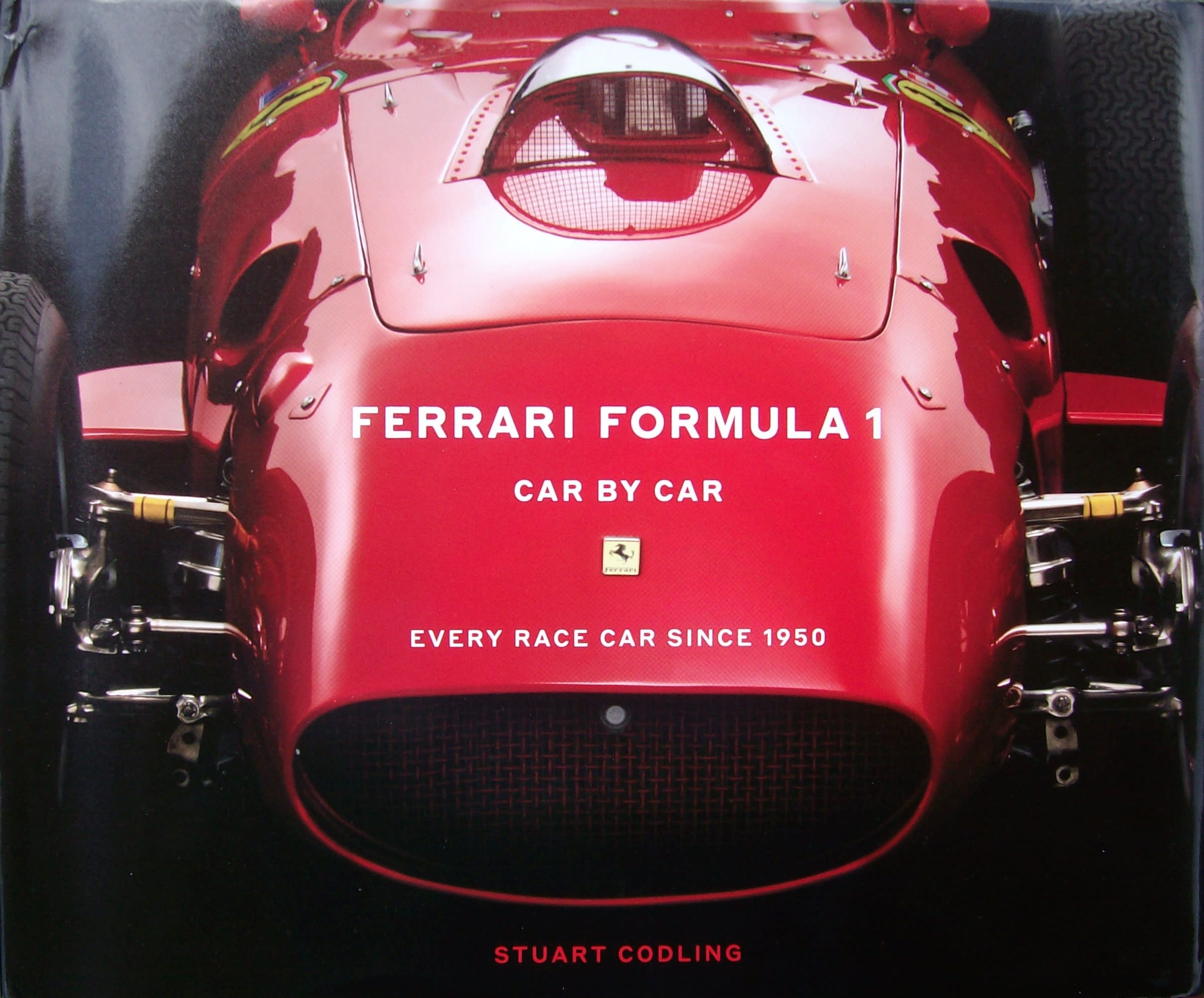 red Ferrari on the cover of the book "Ferrari Formula 1 - Car By Car"