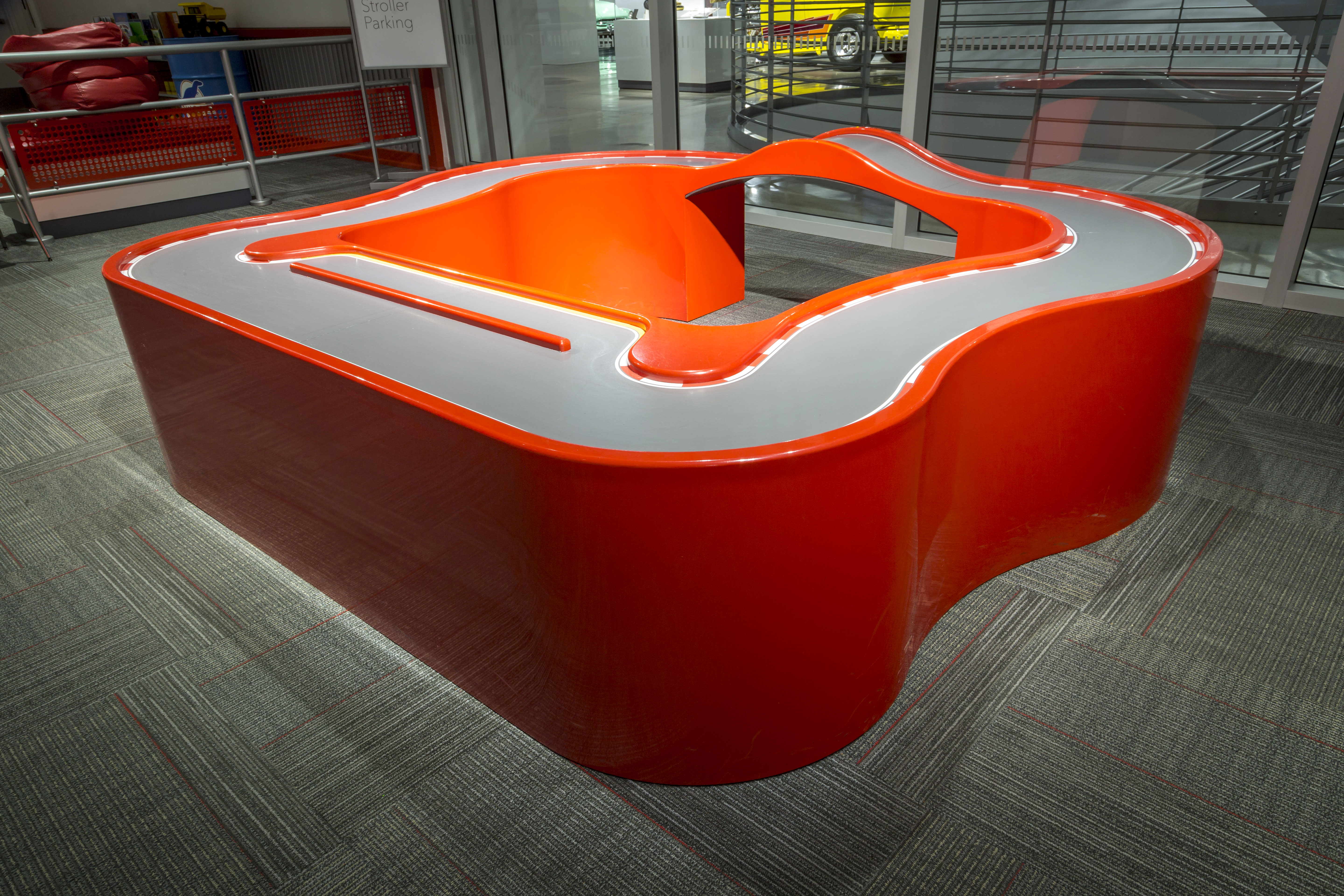 an orange track racing structure, featured at the Petersen Automotive Museum in Los Angeles