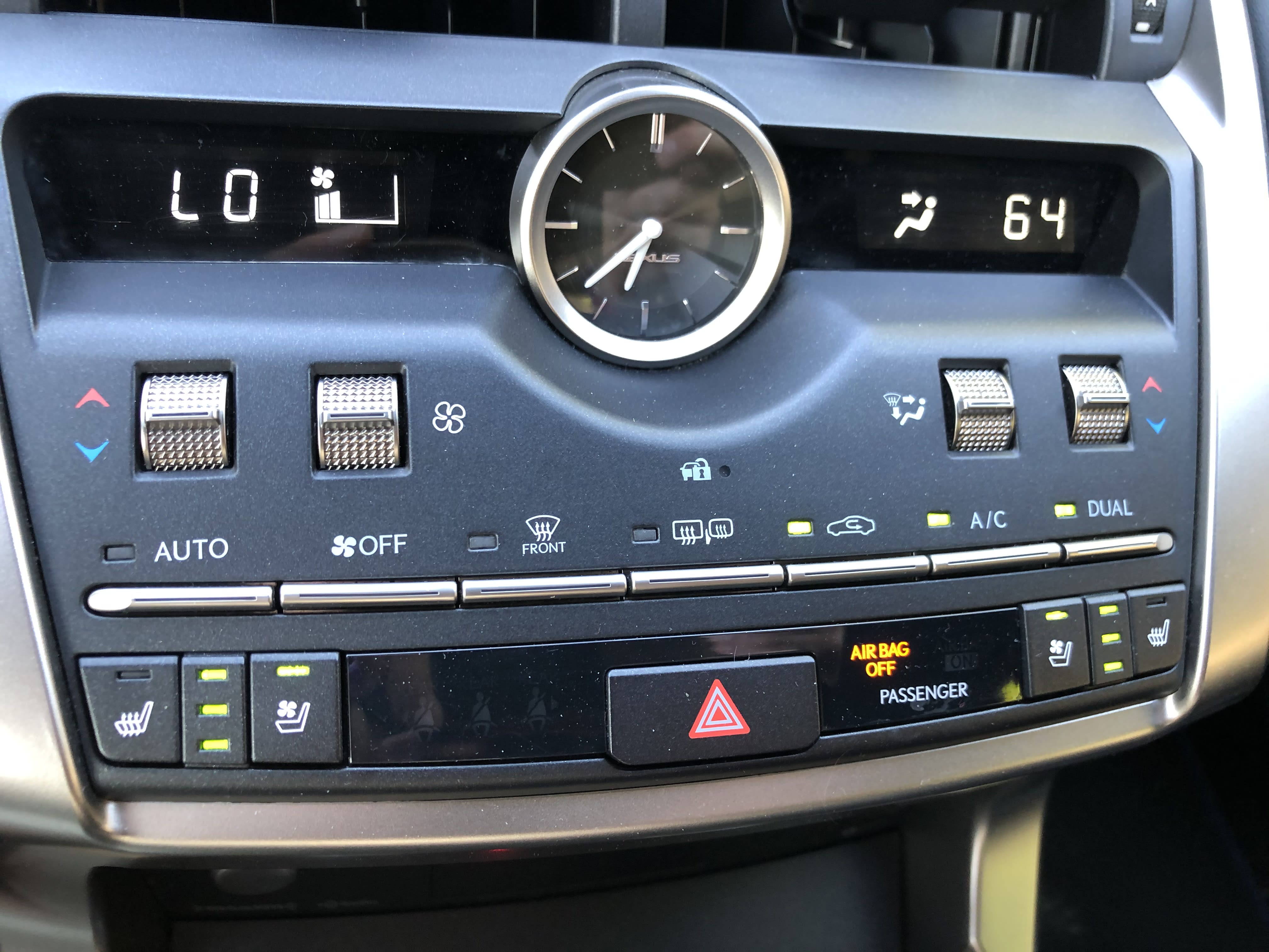 Interior of the Lexus NX300h with the dashboard and clock visible
