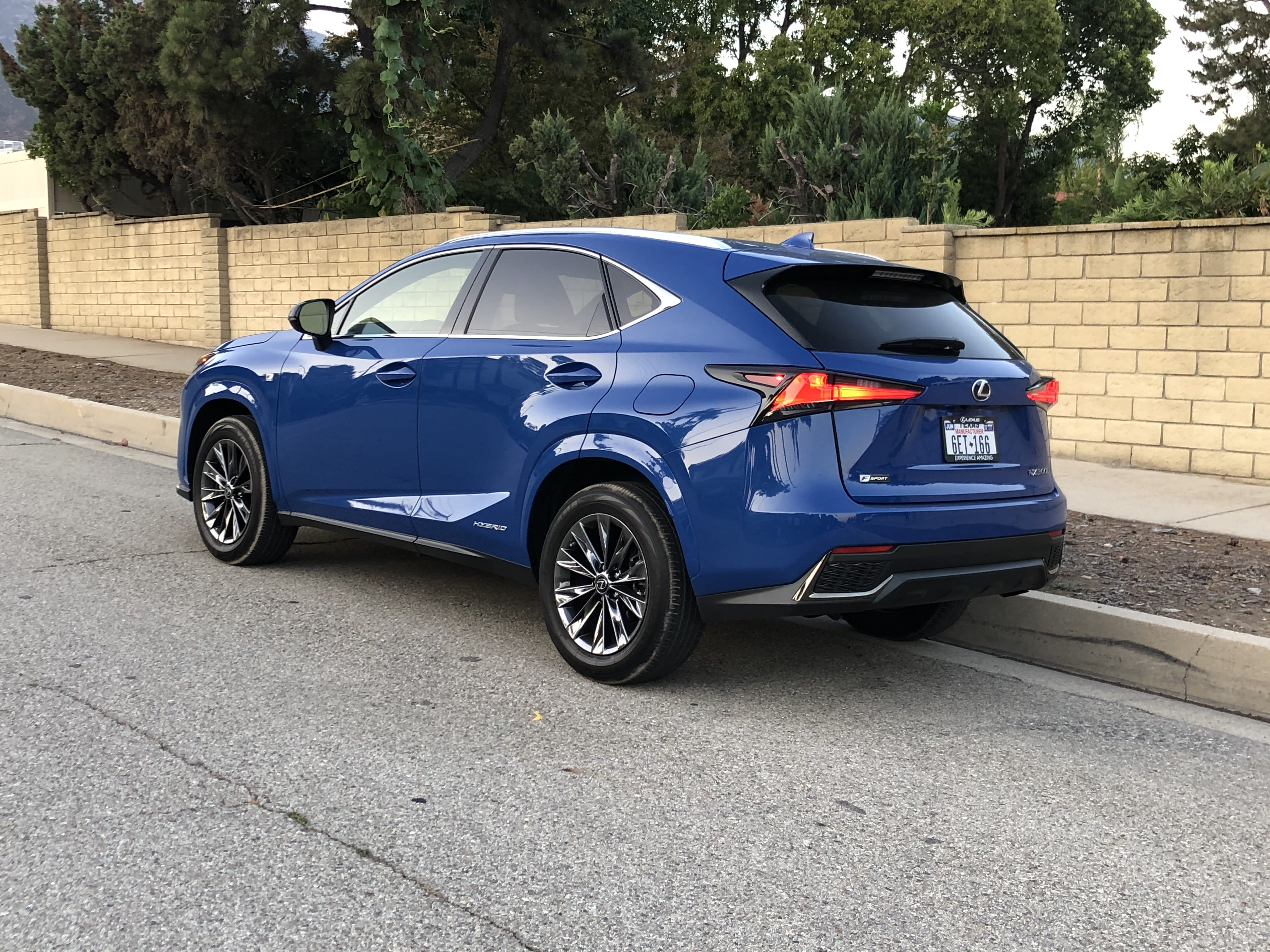 a blue Lexus NX300h parked on the side of the road