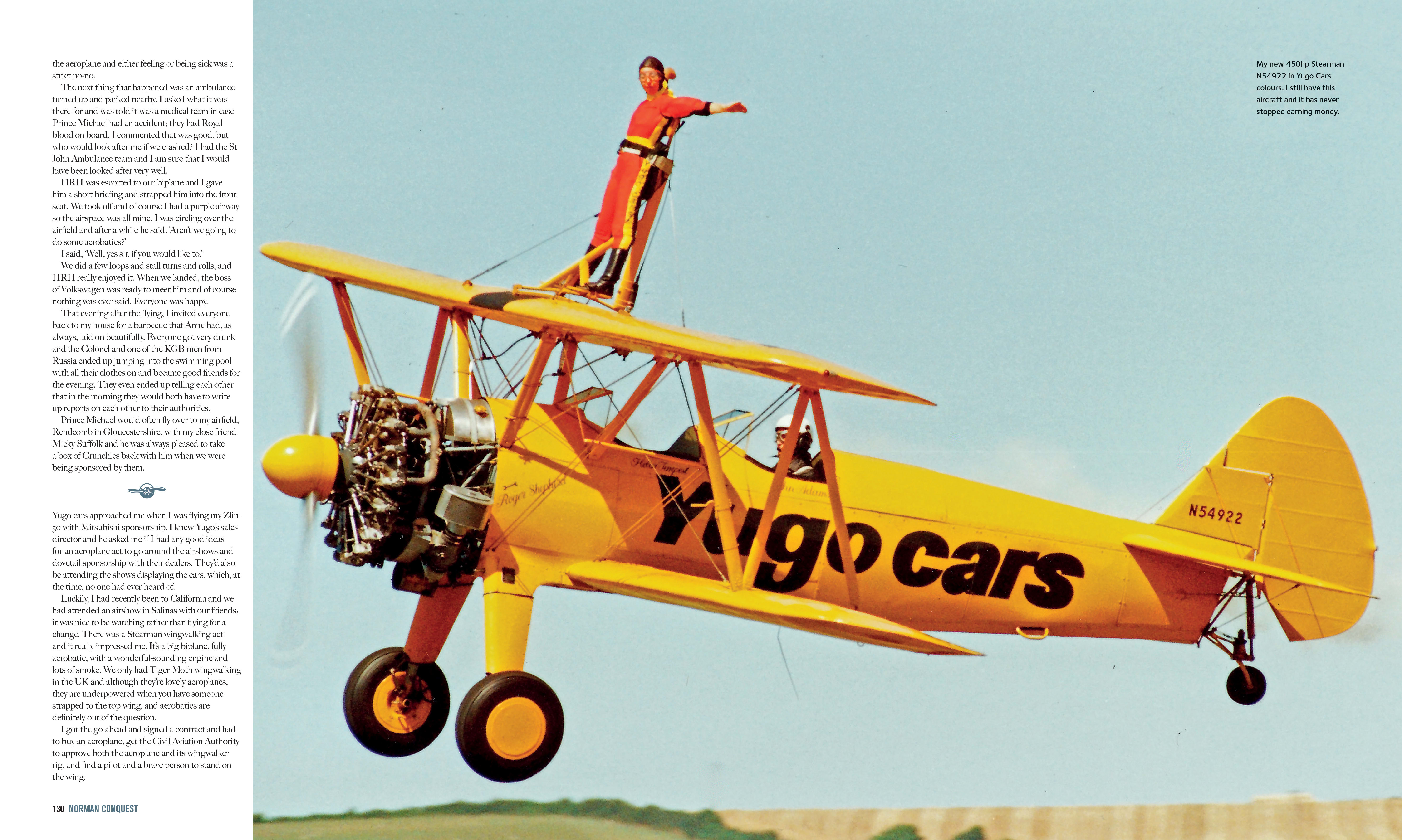 a yellow stunt-plane with a wing-walker atop it, flying past