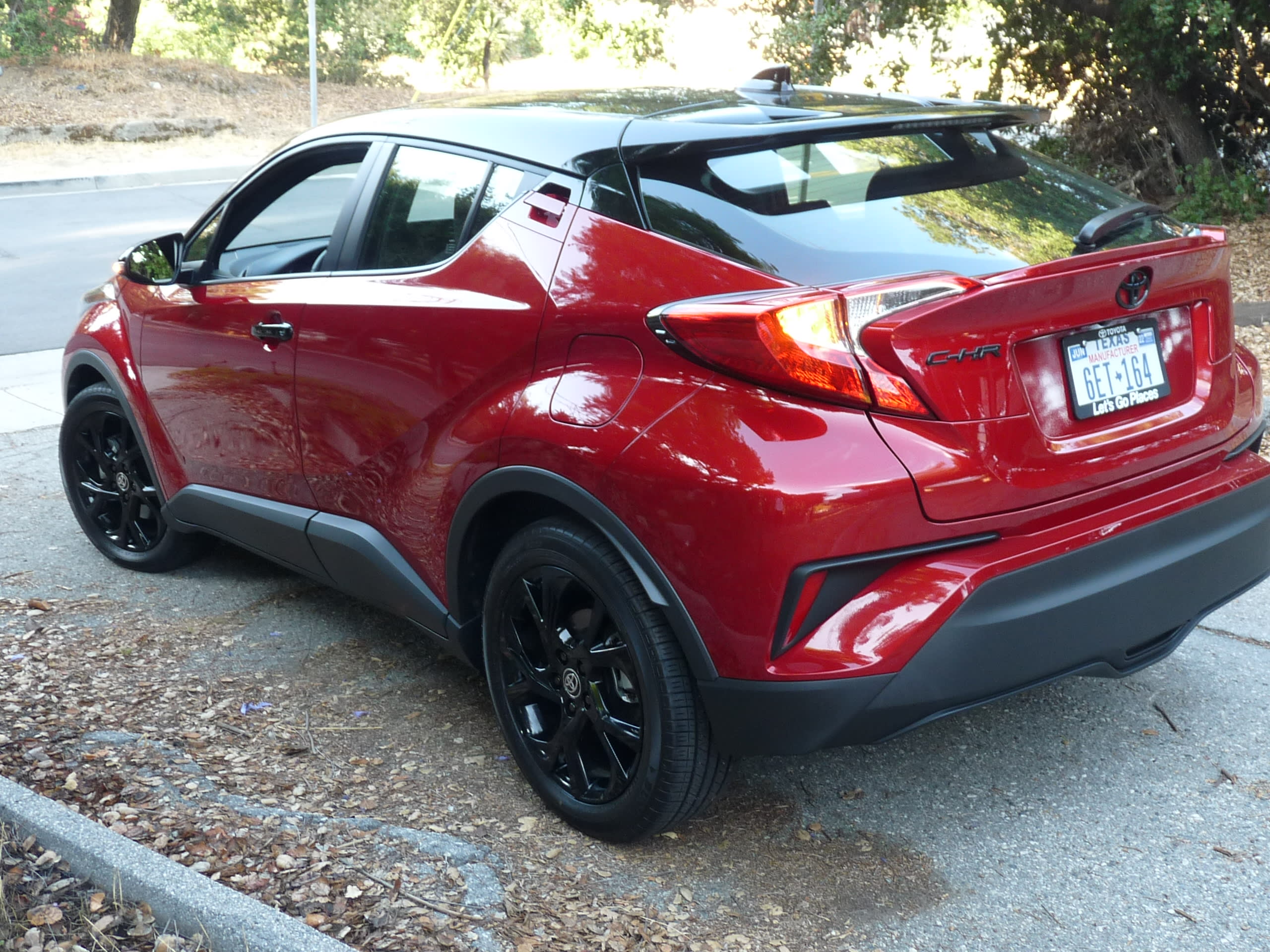 red Toyota CH-R Nightshade Edition with a black roof parked on a driveway