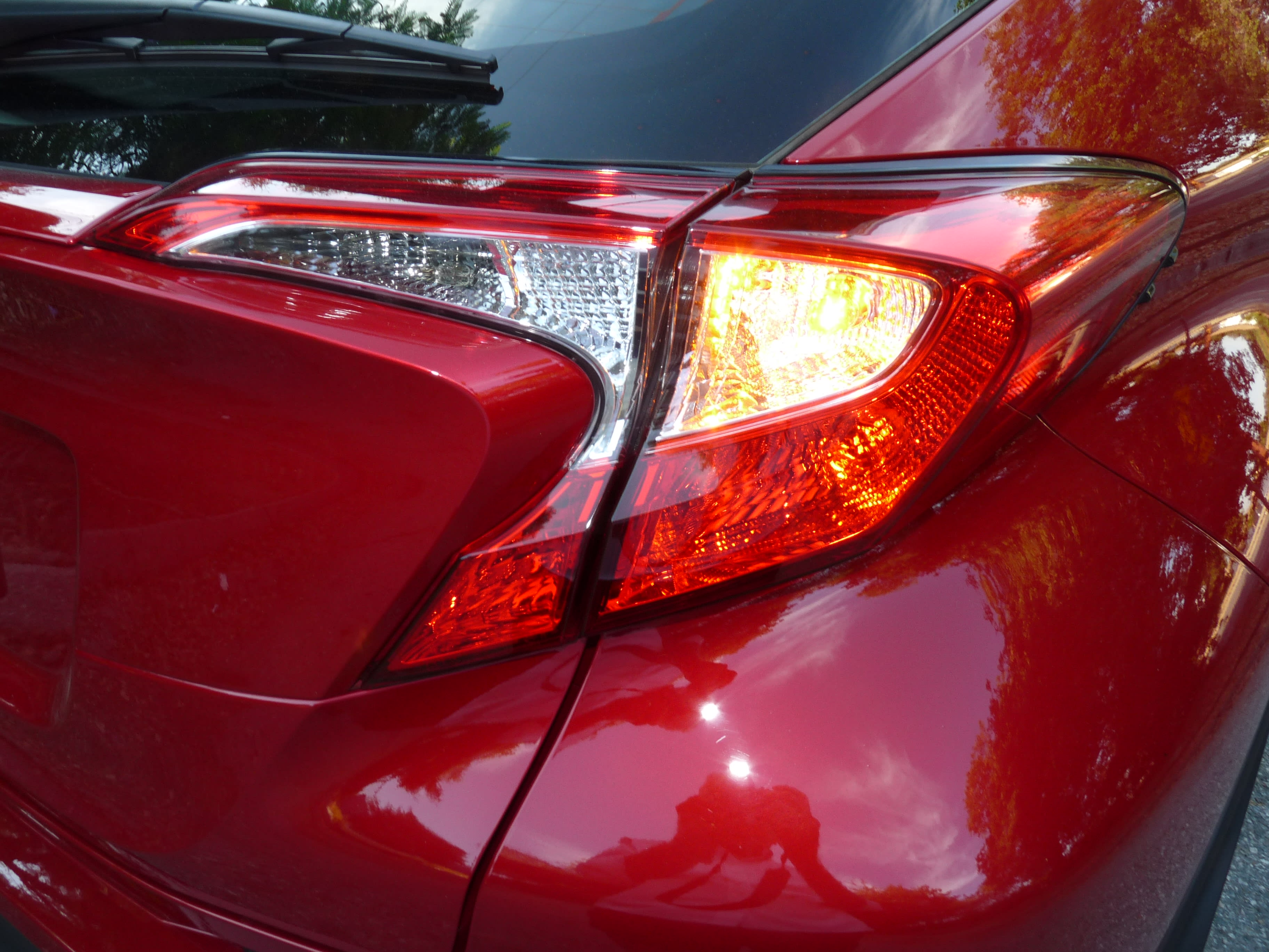 right rear tail-light of the red 2021 Toyota CH-R Nightshade Edition, featuring the very sharp angles in the exterior design.