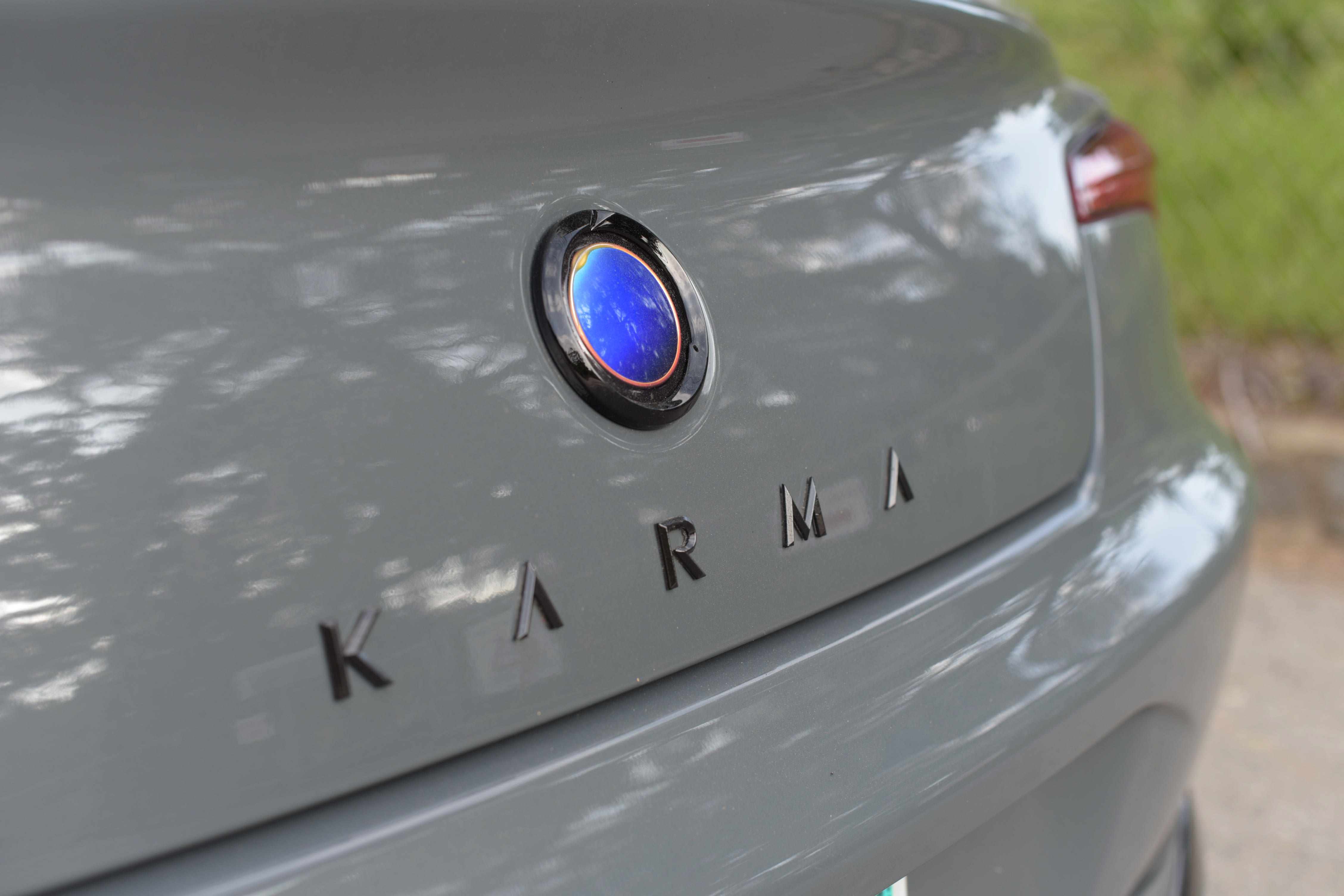 close-up shot of the rear of a Karma GS-6, featuring the blue Karma logo/badge