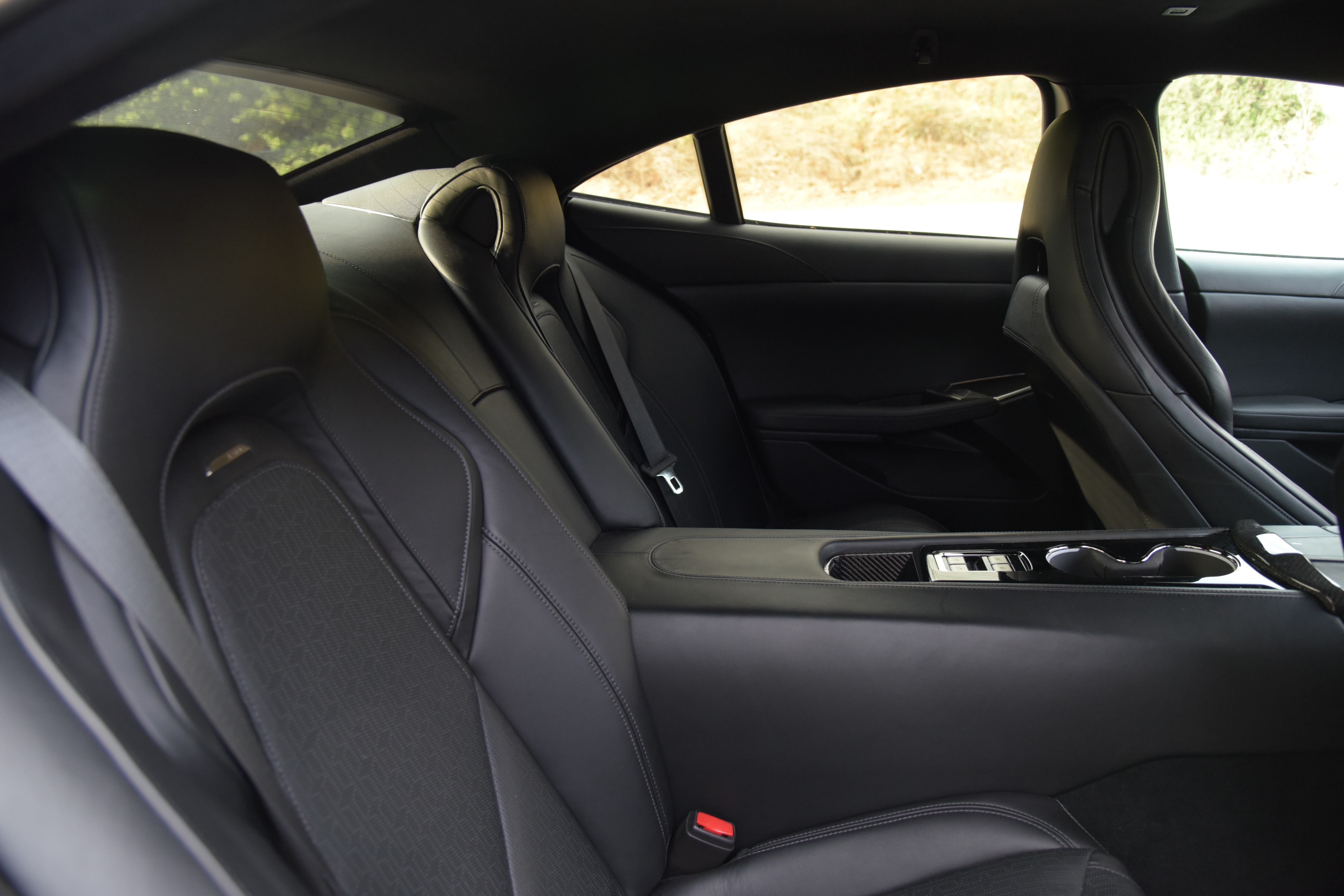back seat of the Karma GS-6 with black interior, seen from the side through an open door