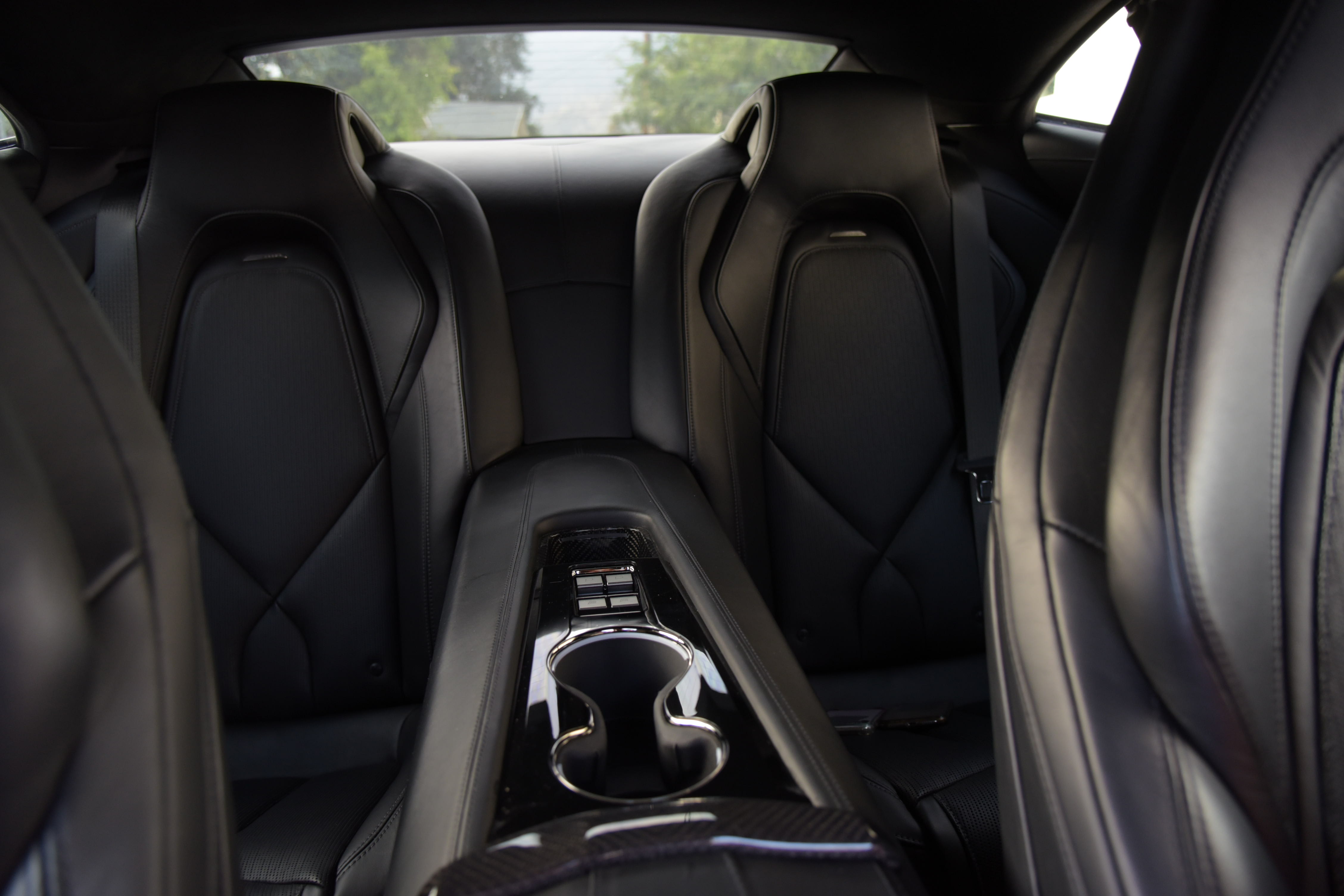 back seat of the Karma GS-6 with black interior, seen from the front, between the two front seats