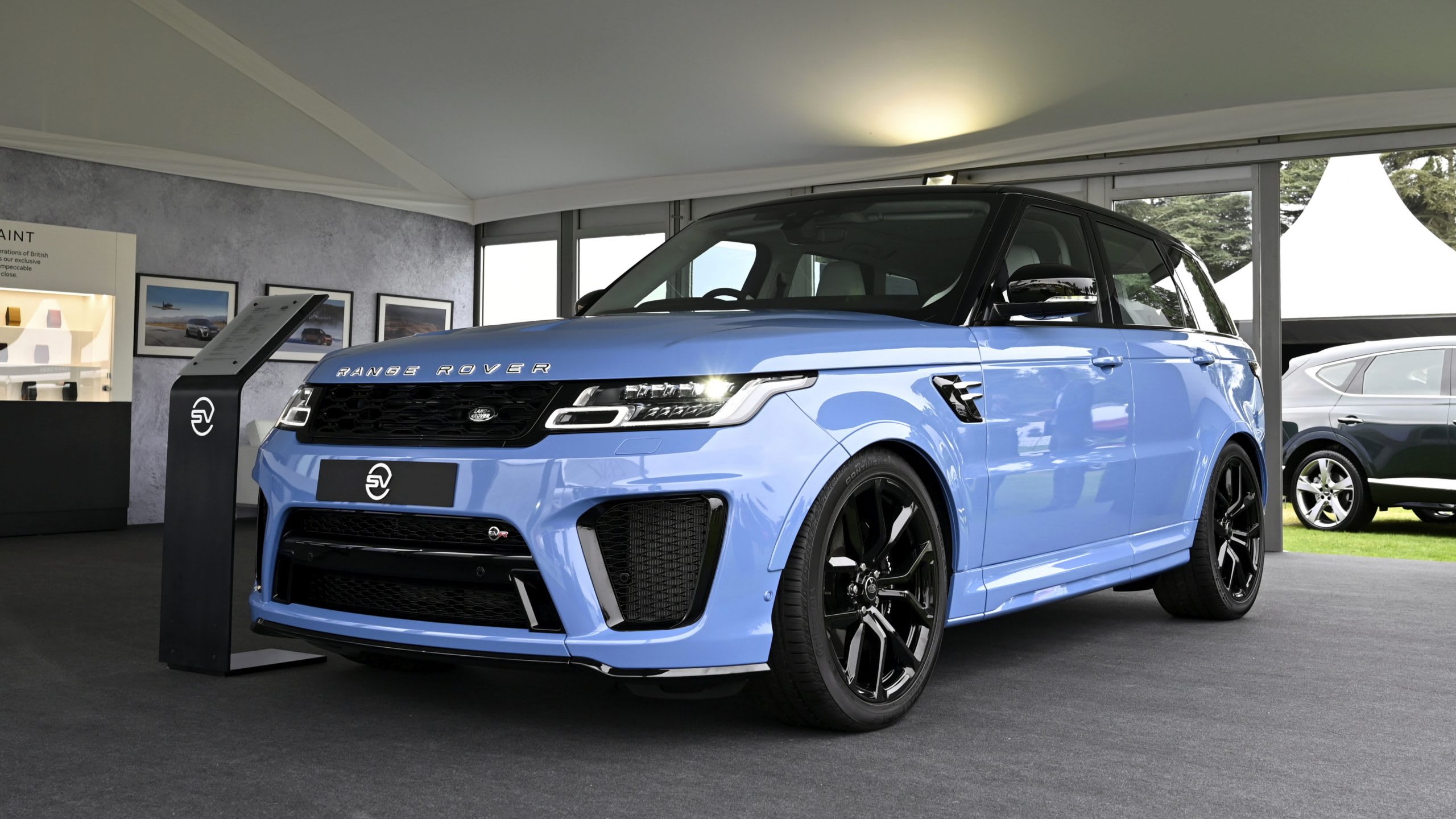 a maya blue Range Rover Sport SVR Ultimate Edition in a showroom.