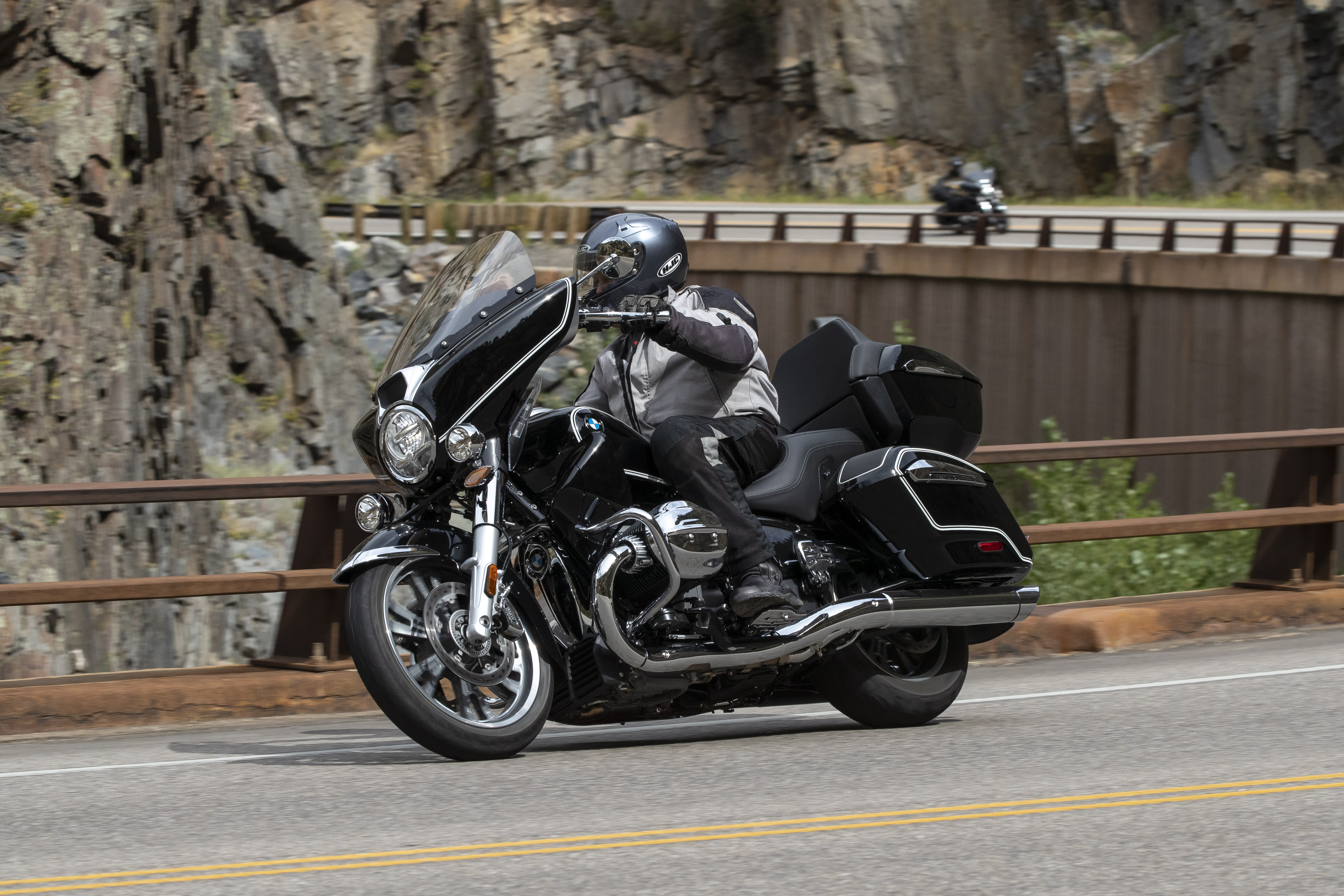 A BMW R 18 Transcontinental just coming off a bridge in the mountains of Colorado