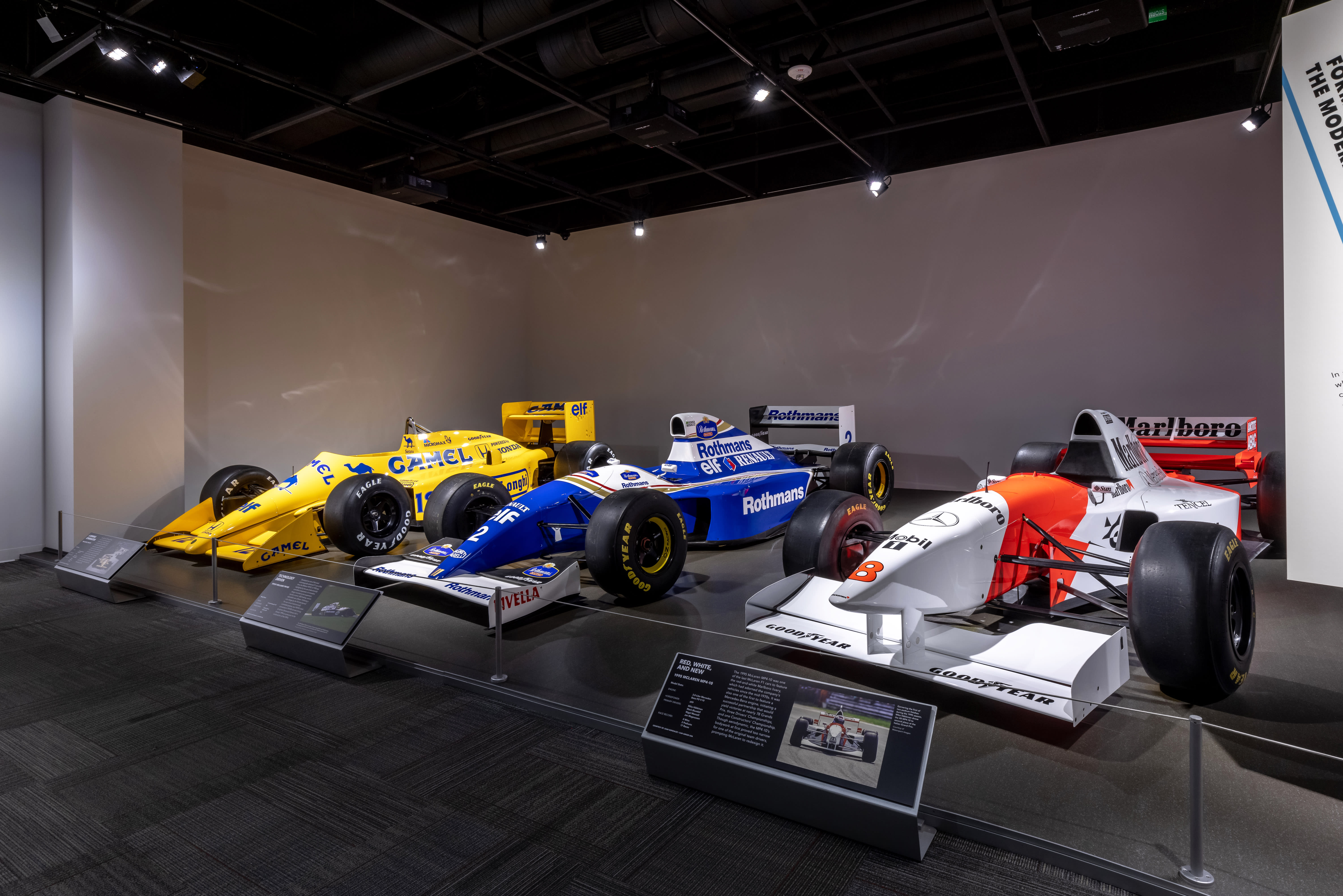 overview of three race cars at the F1 exhibit at The Petersen Automotive Museum