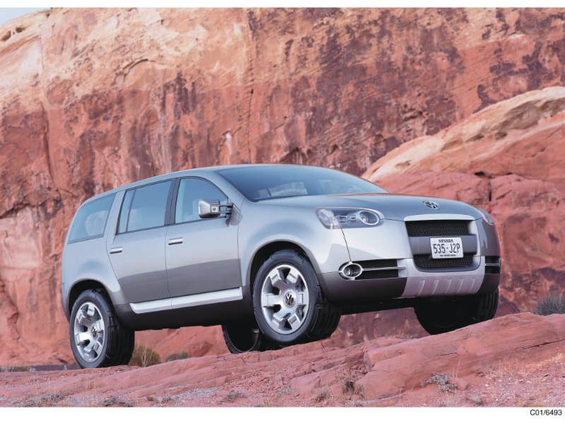 A 2002 VW Magellan concept car, driving on an off-road track in mountains.