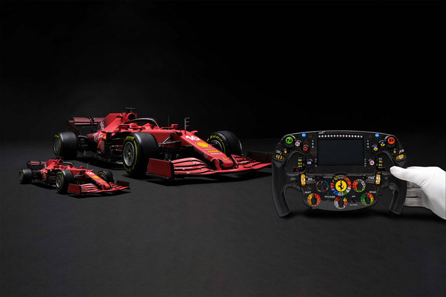 closeup of the Ferrari model car with the steering wheel in the foreground.