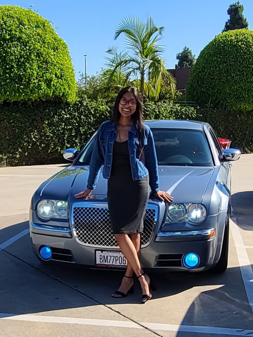 Nancy Kelly standing in front of her 2006 Chrysler 300c at the Heels and Wheels event at the Marconi Automotive Museum
