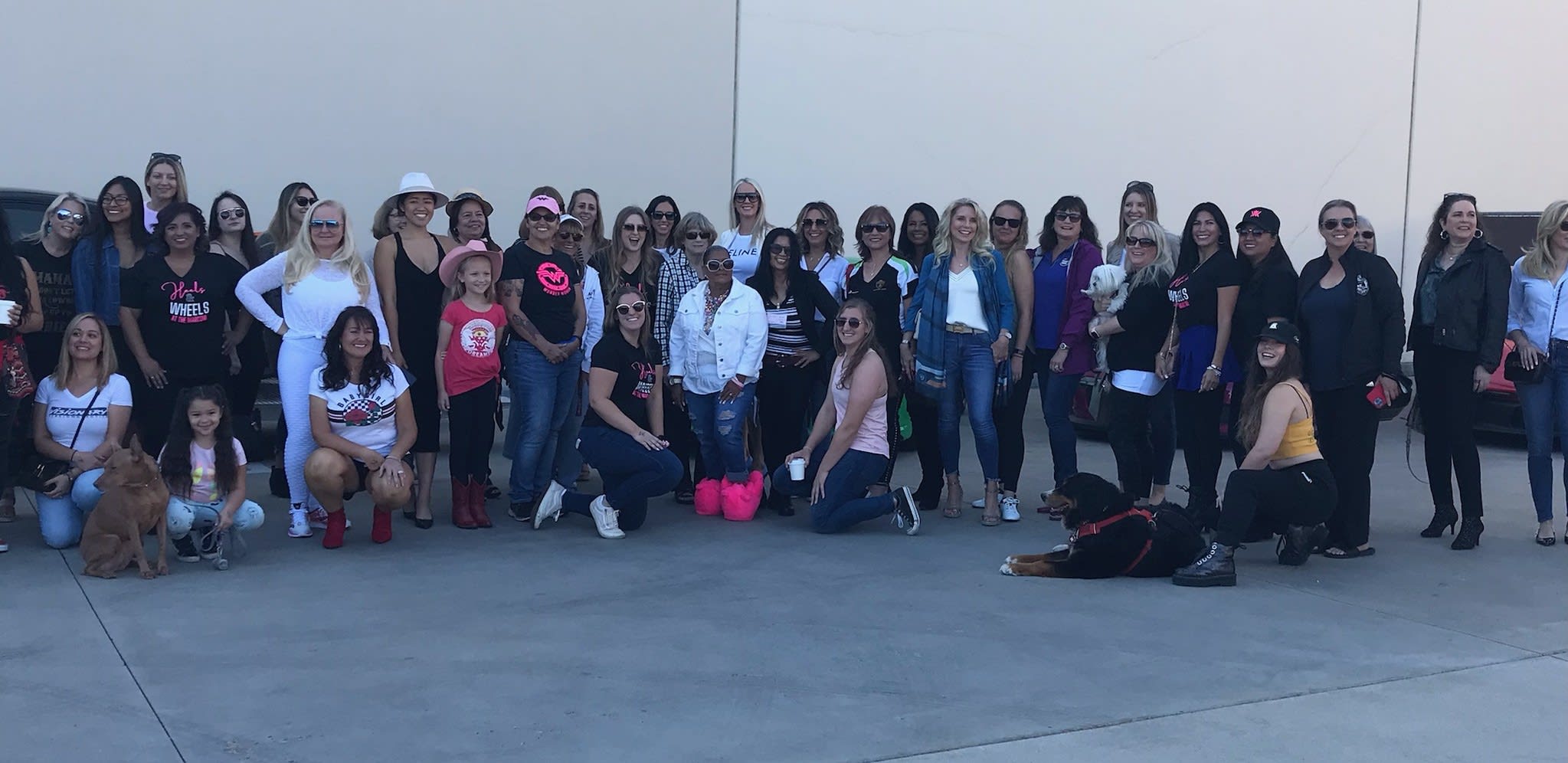 the attendees of Heels and Wheels at the Marconi Automotive Museum, lined up outside of the museum.