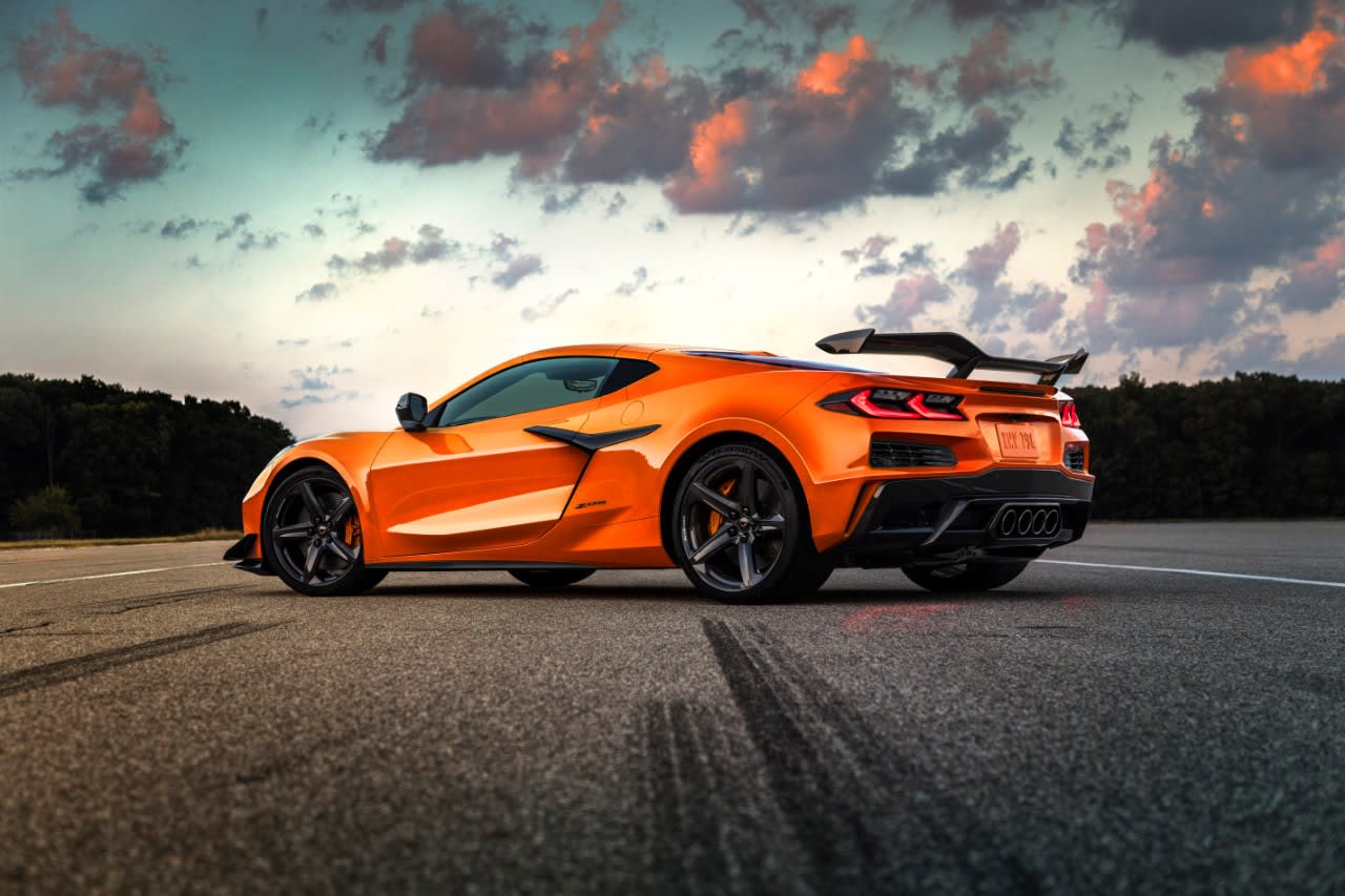 An orange 2023 Chevrolet Corvette Z06 standing on an airport runway.