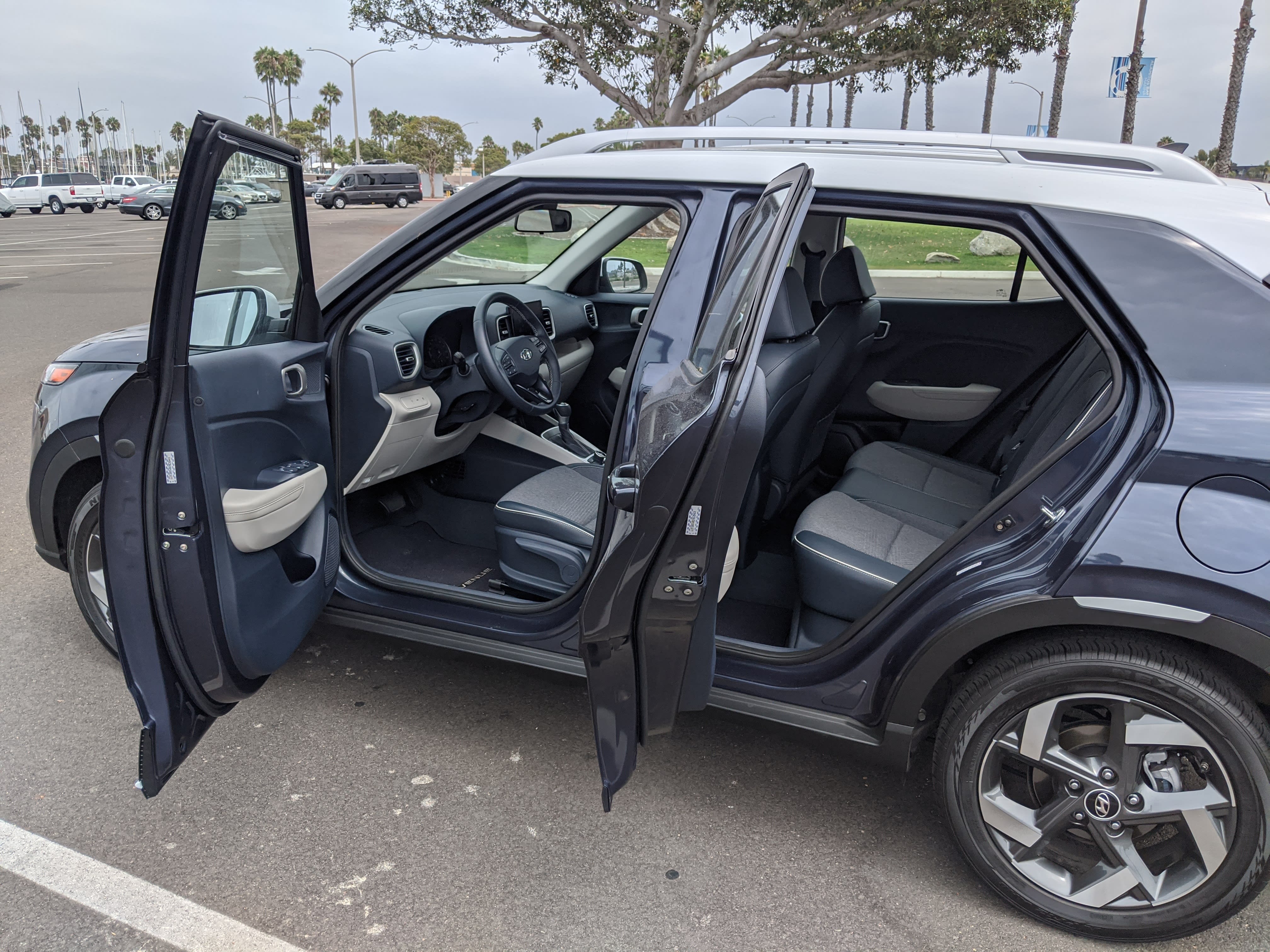 A denim blue 2021 Hyundai Venue Denim with both side doors open, showing the interior.