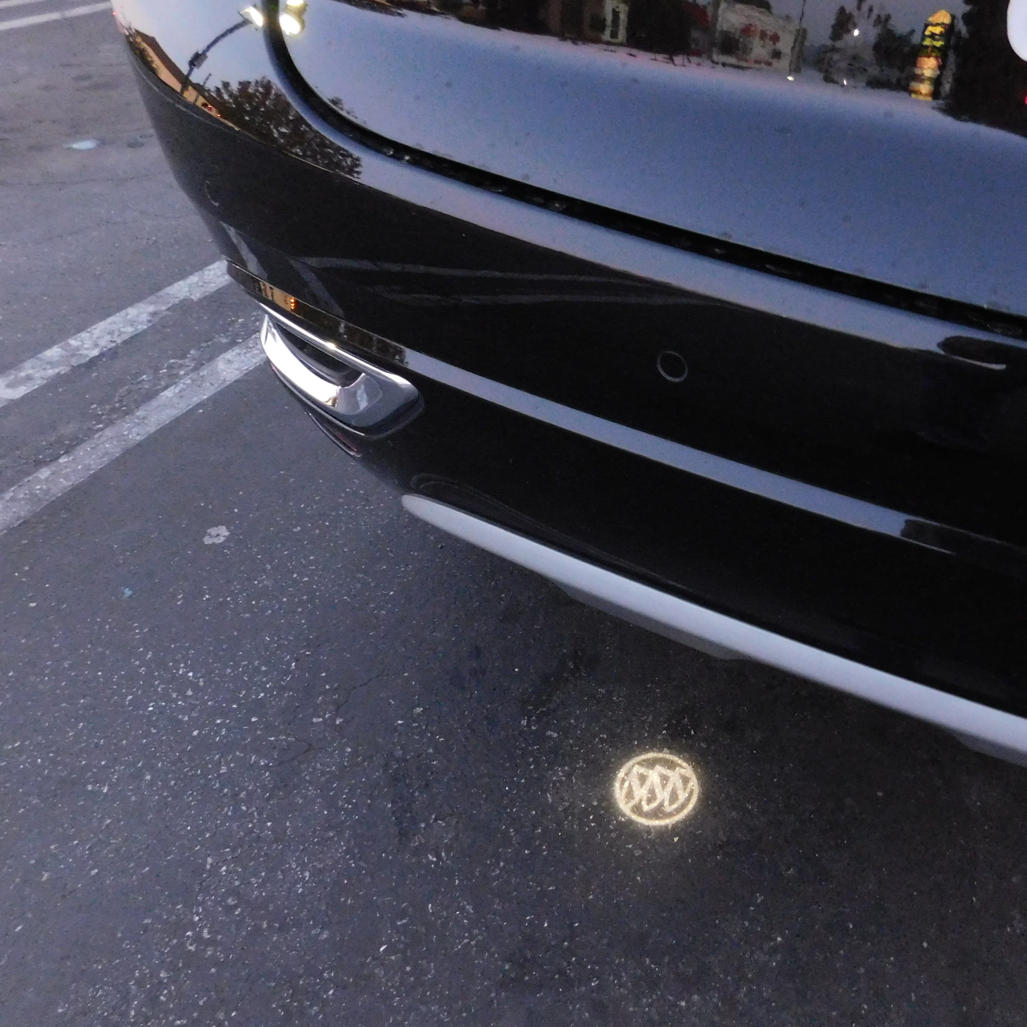 a shot of the Buick logo projected under the rear bumper, right where you should stick your foot to open the rear tailgate.