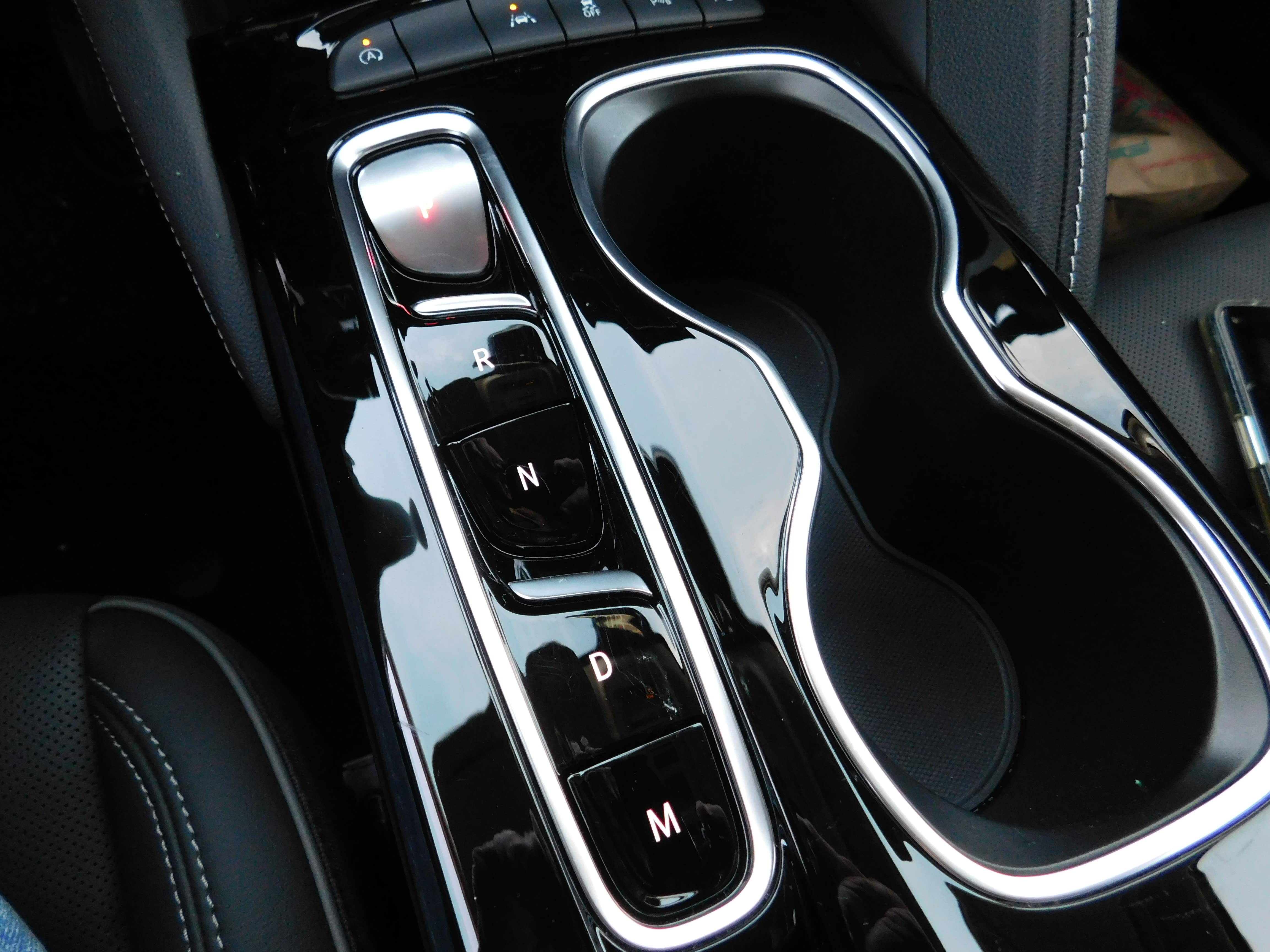an image of the center divider between the front seats of the 2022 Buick Envision Avenir.