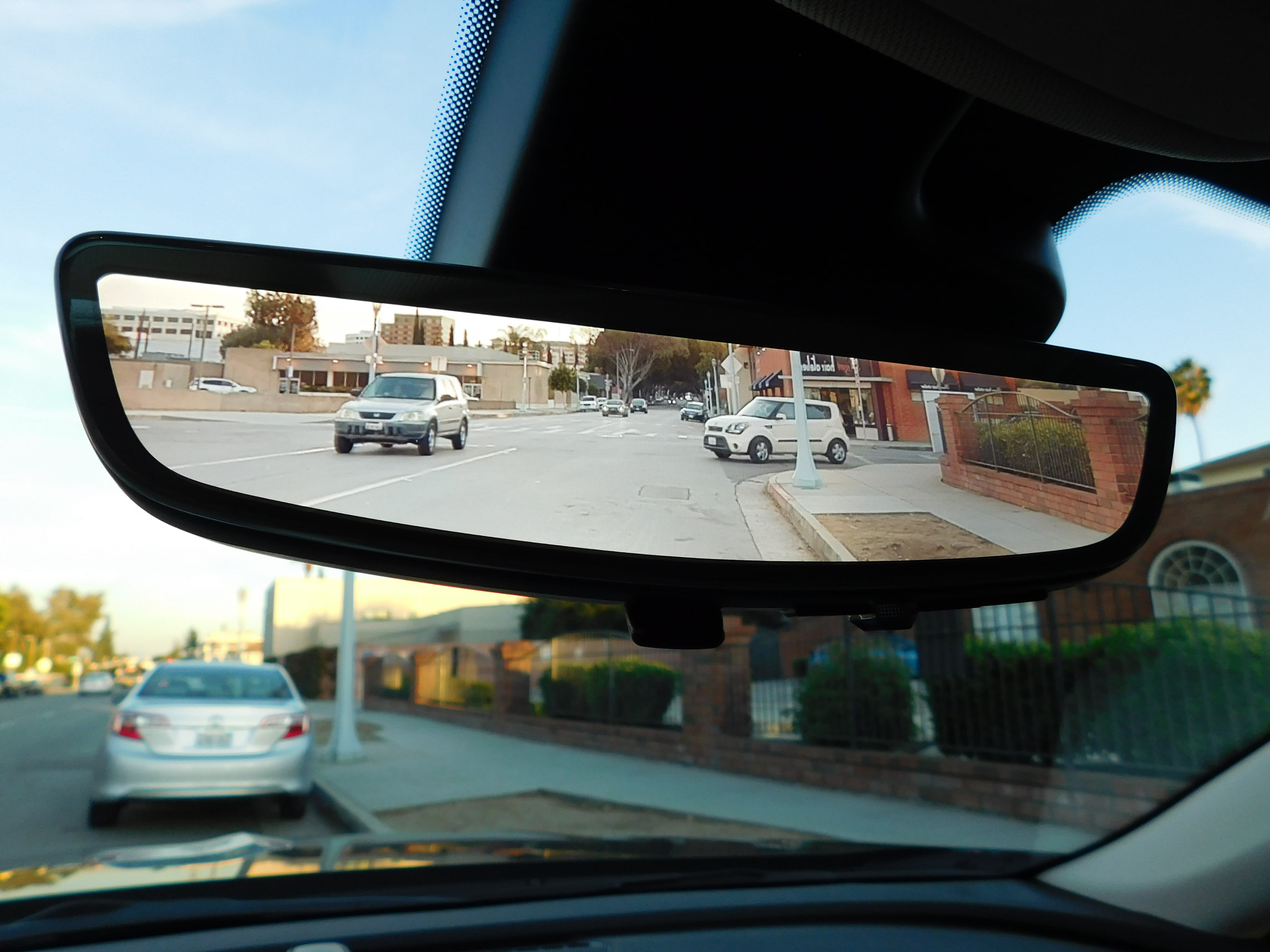 a close-up photo of the inside rearview mirror in the 2022 Buick Envision, featuring the live camera feed showing what's behind the car.