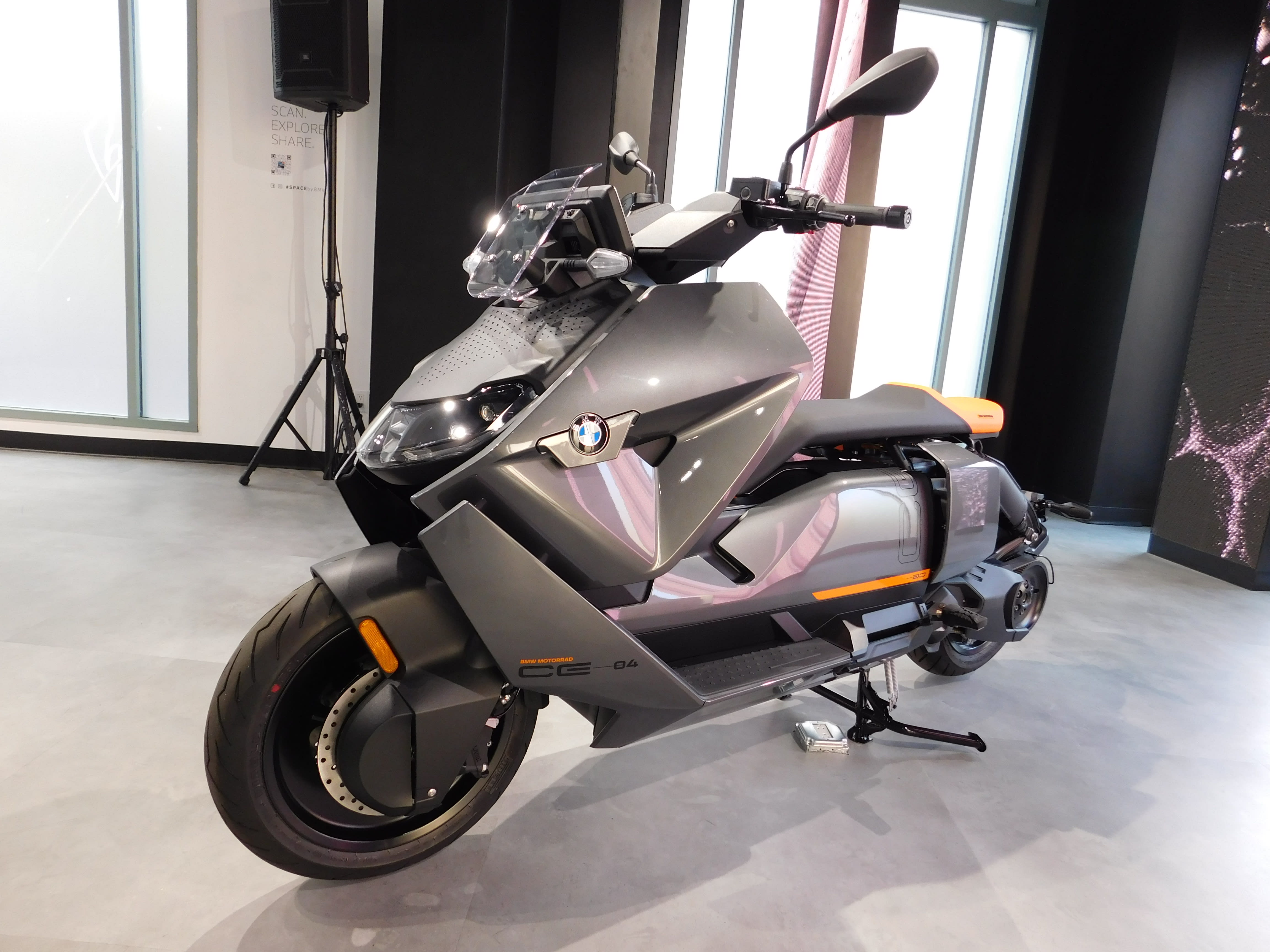 a gray BMW Motorrad CE 04 Electric Scooter on display at the LA Auto Show of 2021