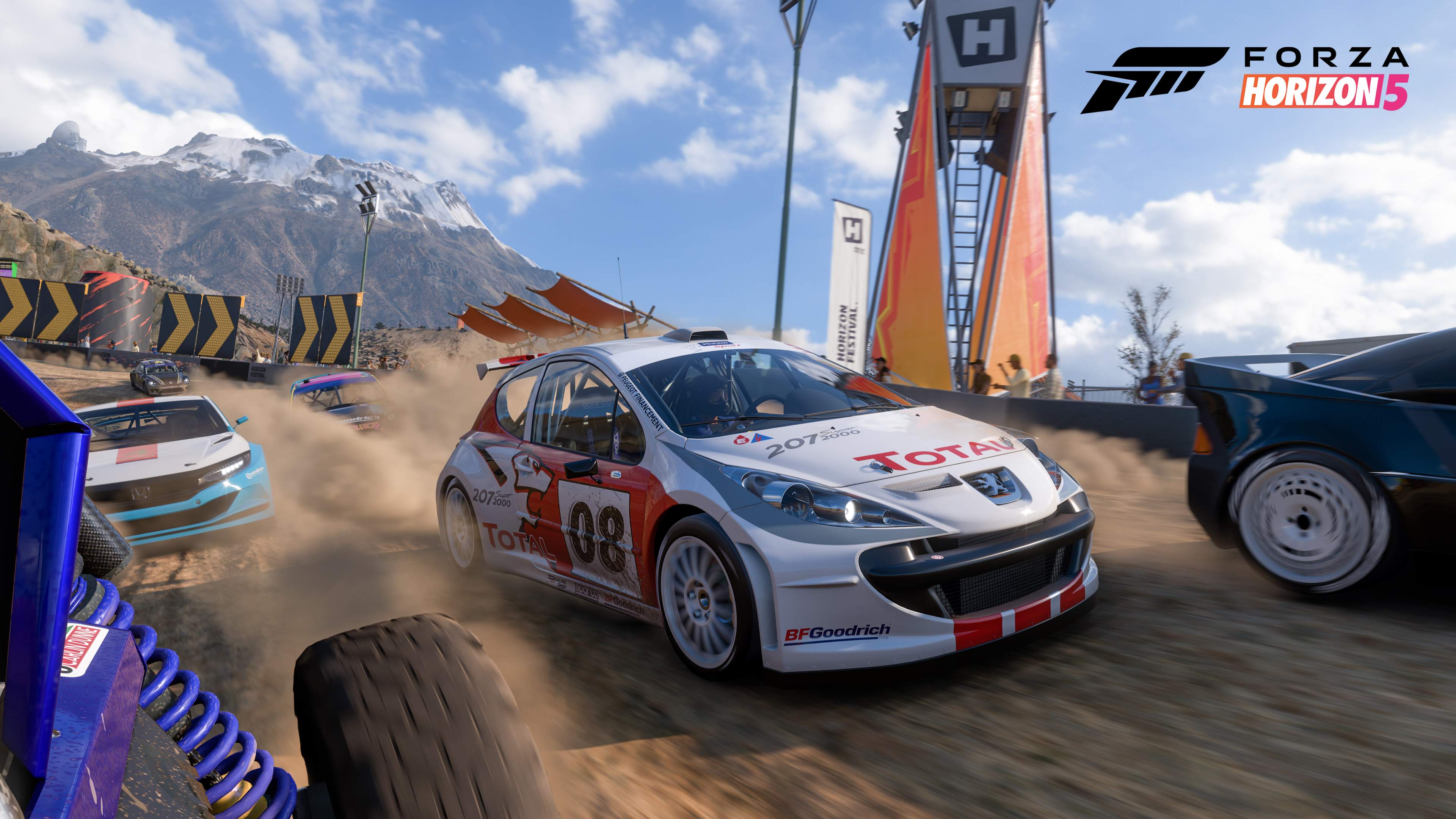 image from the Forza Horizon 5 video game with a Peugeot rally car barreling down a route, with other rally cars all around it.