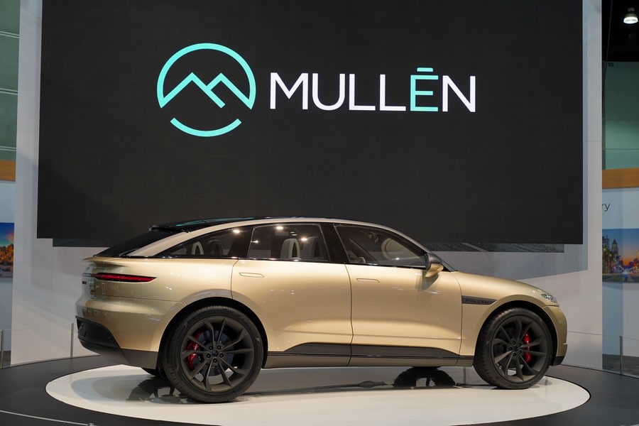 A golden colored Mullen Five on display at the LA Auto Show
