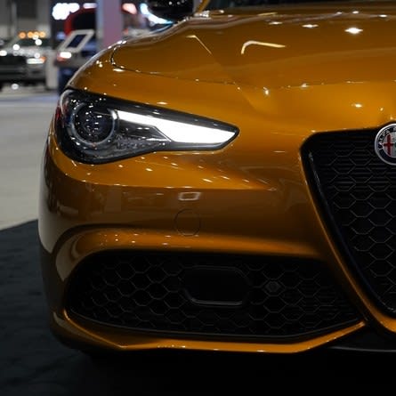 the right front facia of an Alfa Romeo, very orange in color.