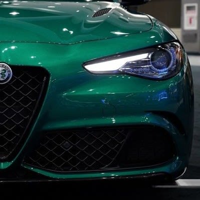 the left front facia of an Alfa Romeo, dark green in color.