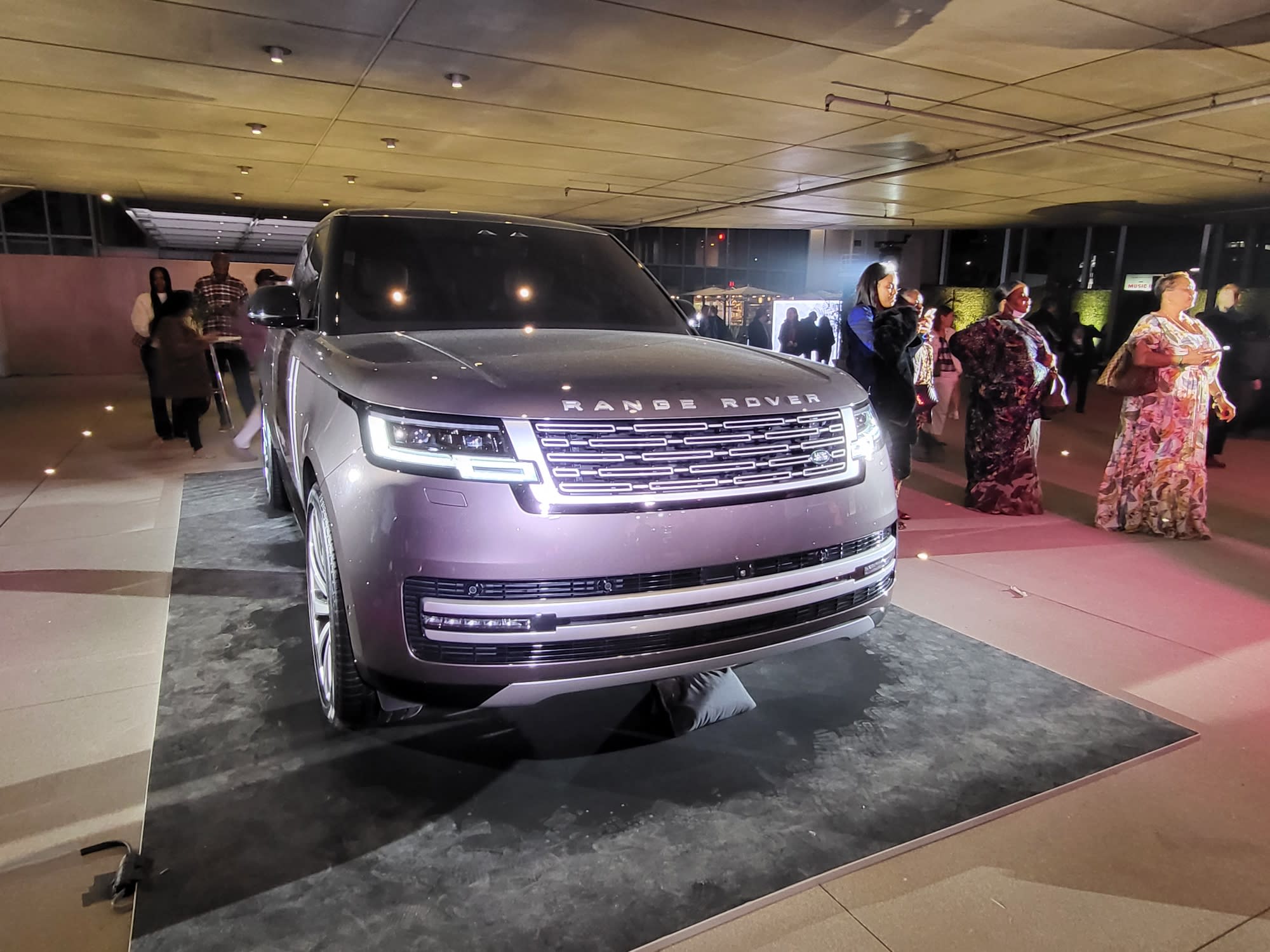 a silver Range Rover on display at the launch in Los Angeles, with spectators around it