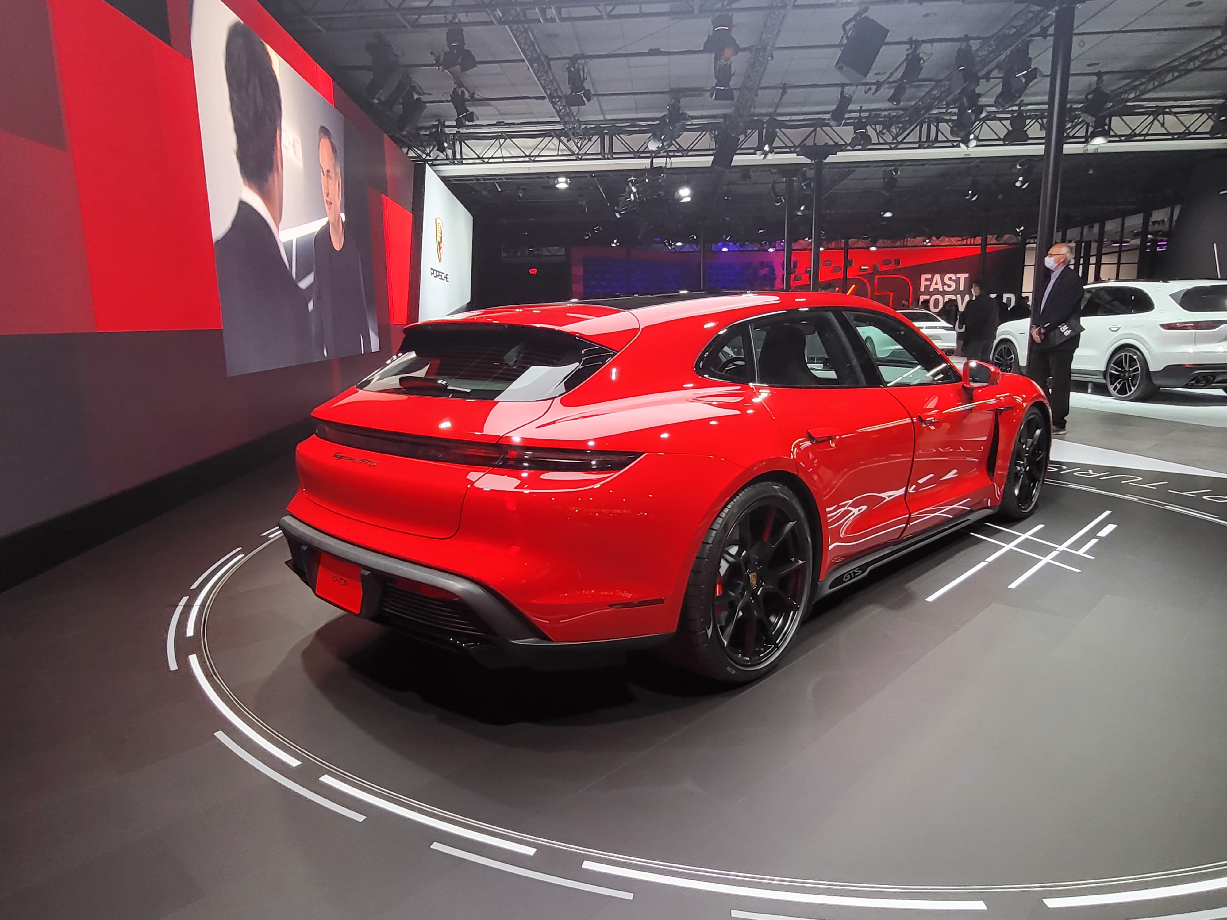 a very red Porsche Taycan GTS Sport Turismo on display at the Los Angeles Auto Show 2021.