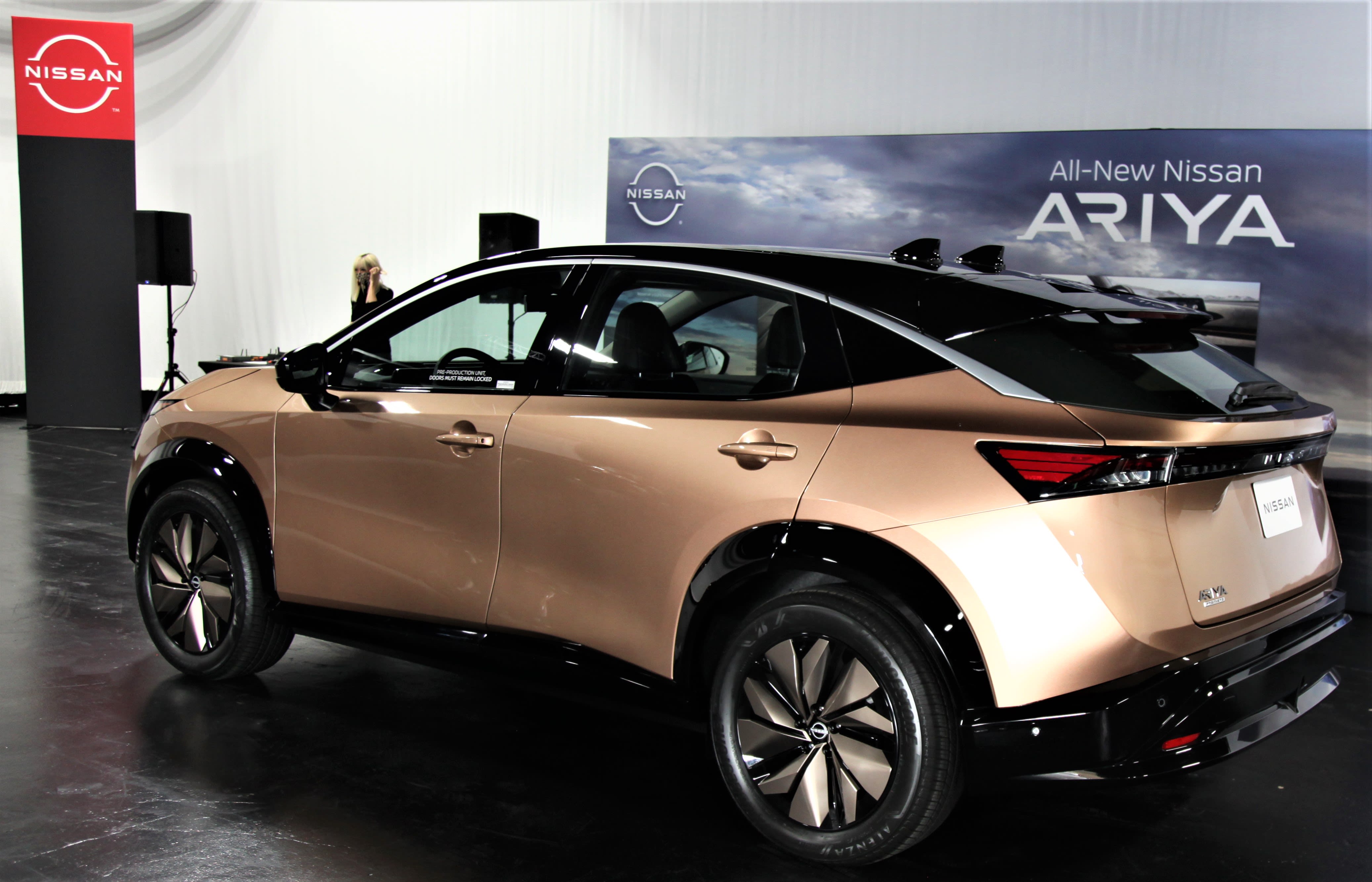 a gold-colored Nissan Ariya displayed at Autopia 2099.
