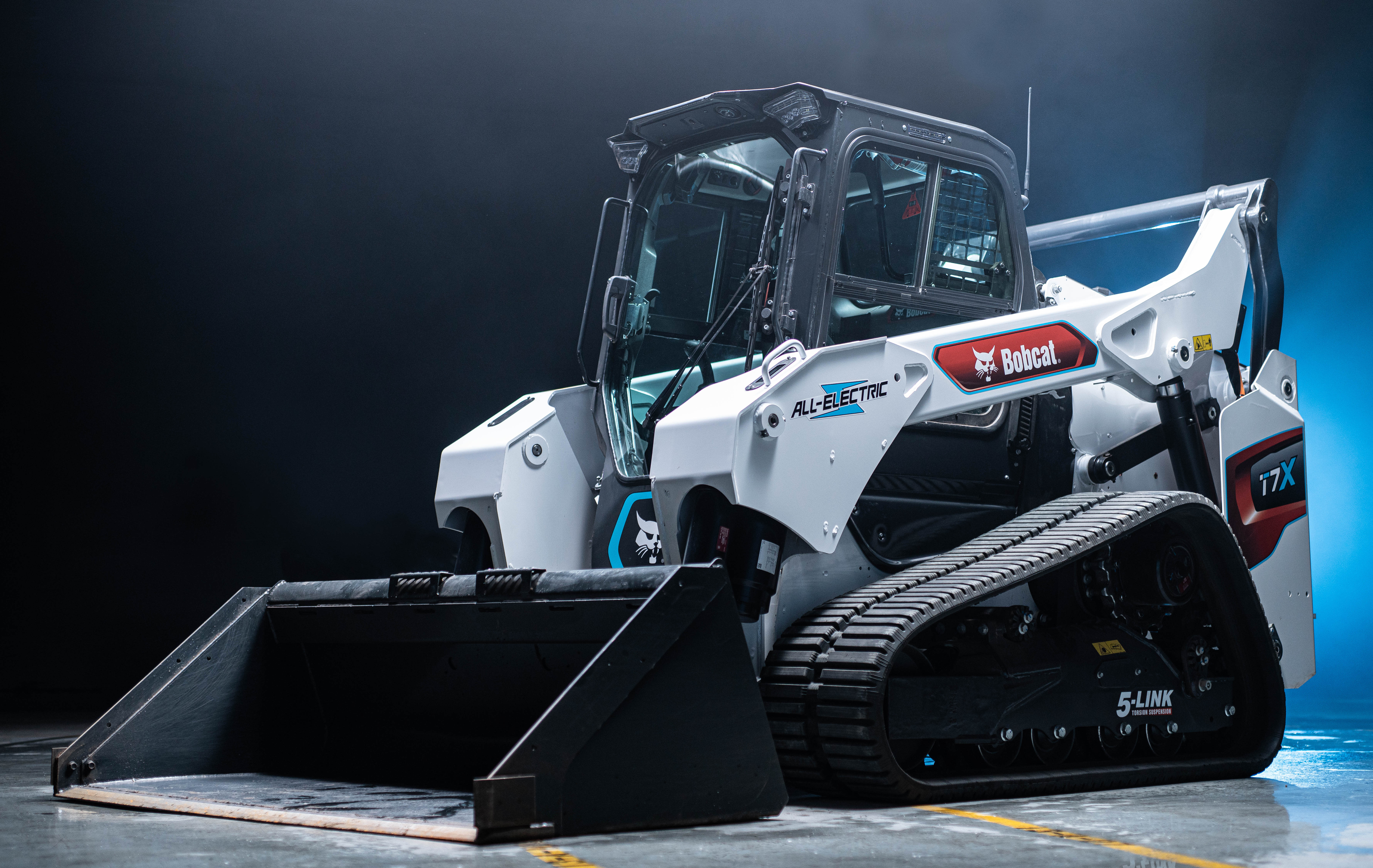 A white-colored but striped Bobcat T7X Compact Track Loader.