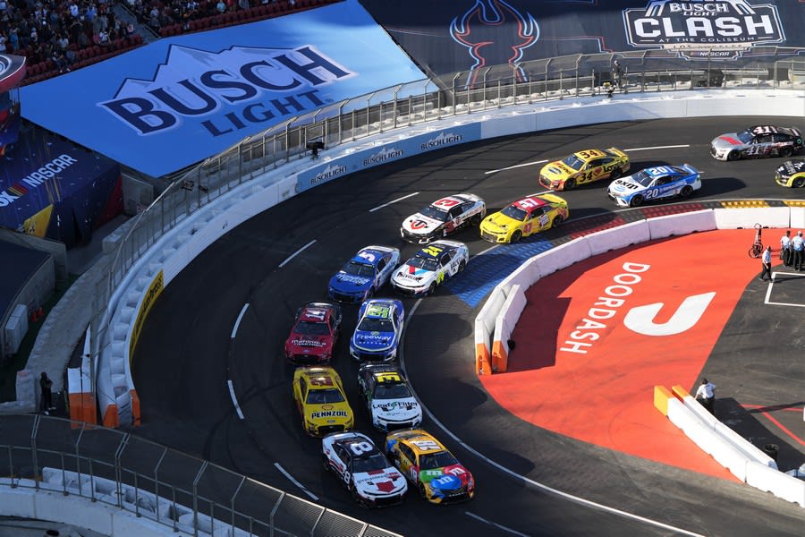 NASCAR racers coming through the turn at the race at the LA Coliseum.