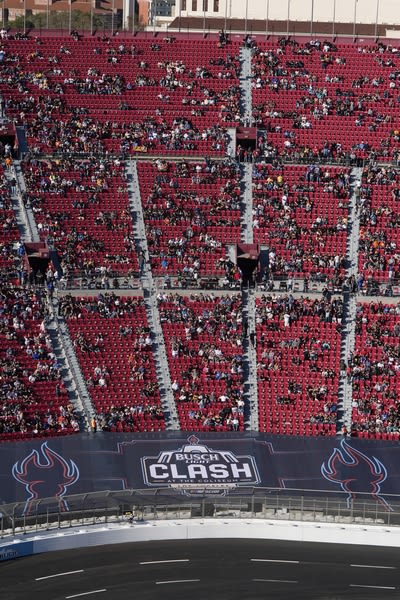 crowds sitting in the bleachers of the LA Coliseum watching the NASCAR race