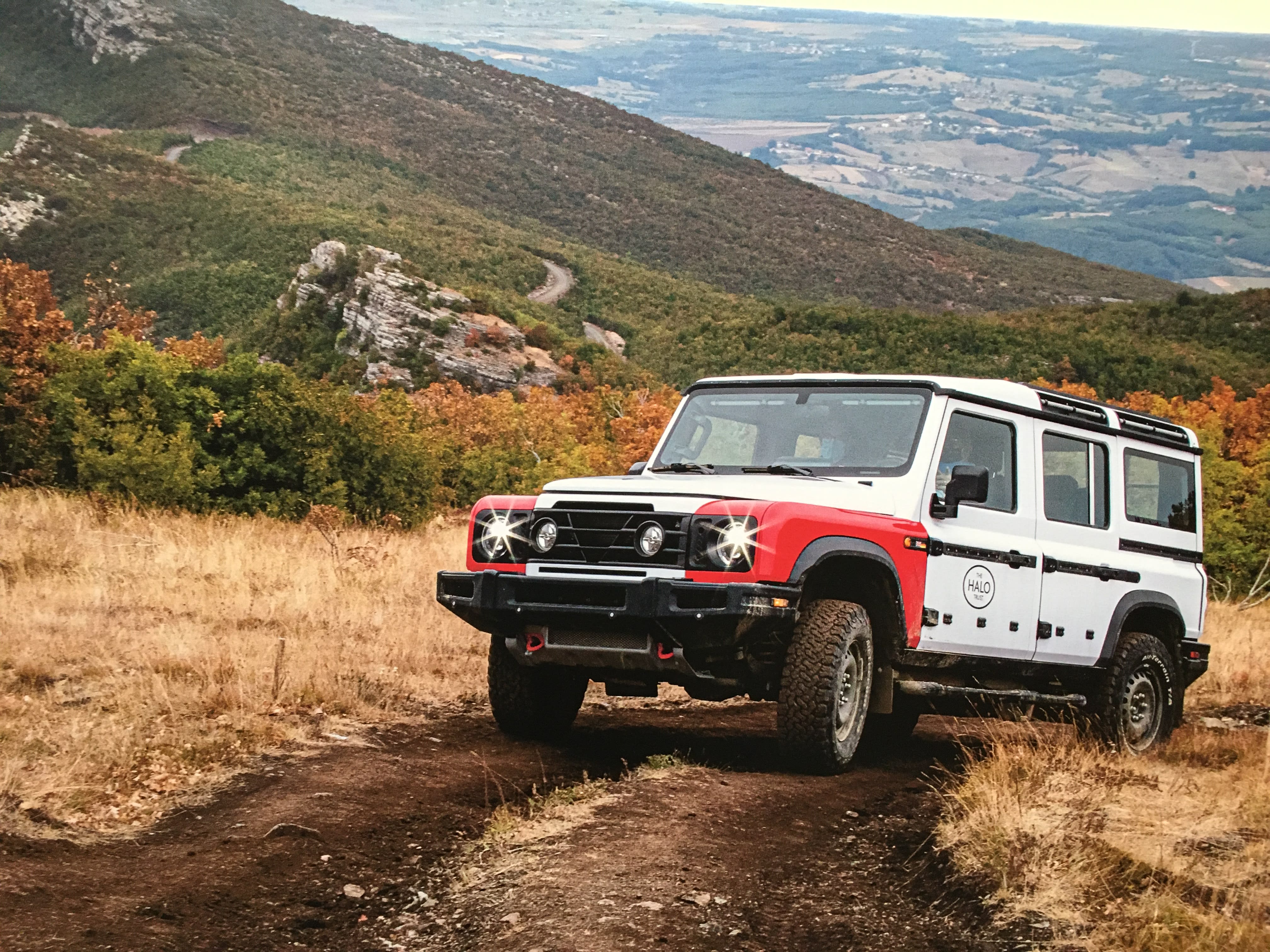 the INEOS Grenadier on an off-road course on a hilly landscape