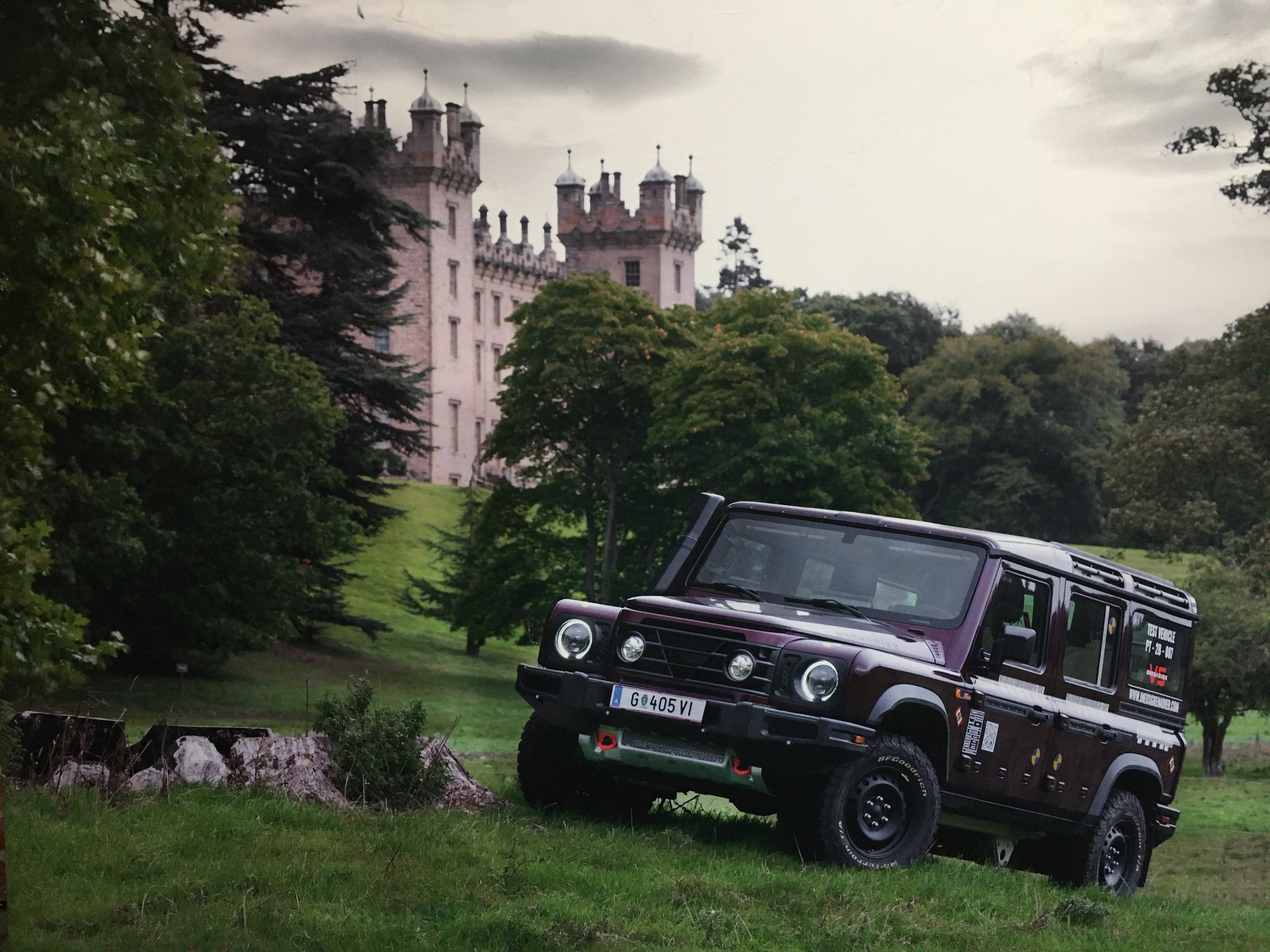 The INEOS Grenadier driving on grassy hills in England