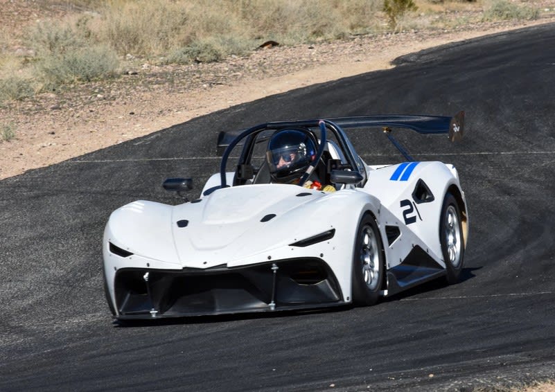 a white race car - the Rush SR - racing on the track during VARA Hillclimb 2022.