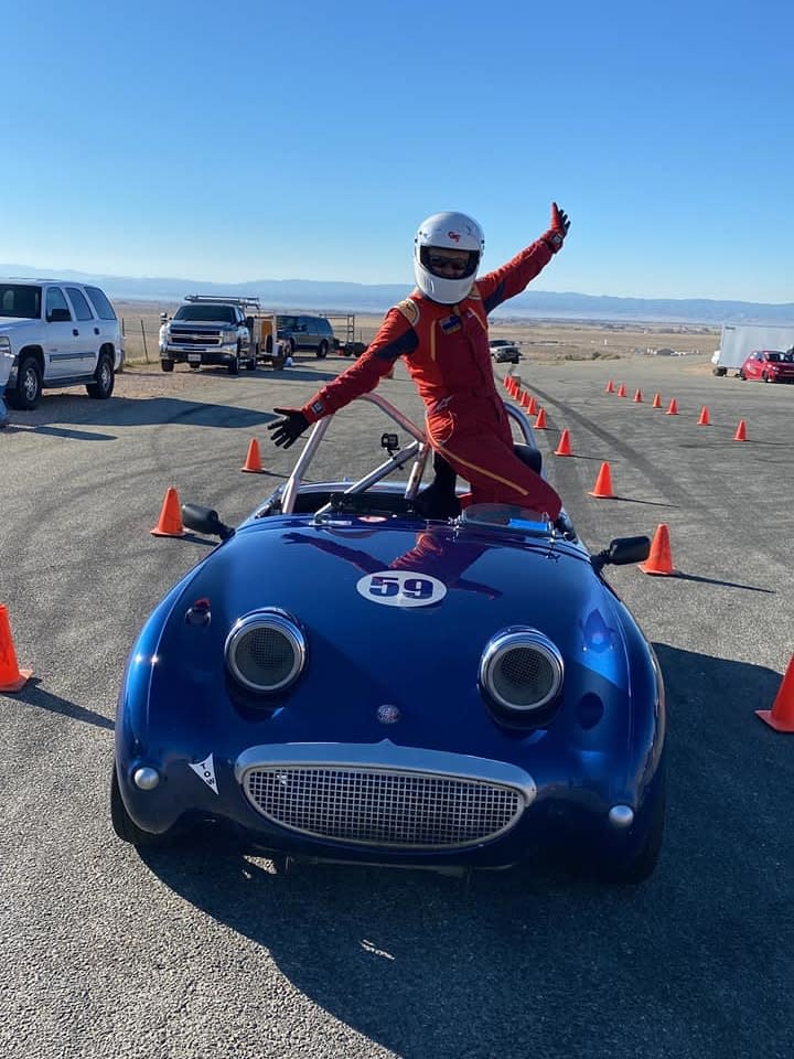 Shelley Hiestand’s blue Vintage Sprite, with the driver celebrating in the car.