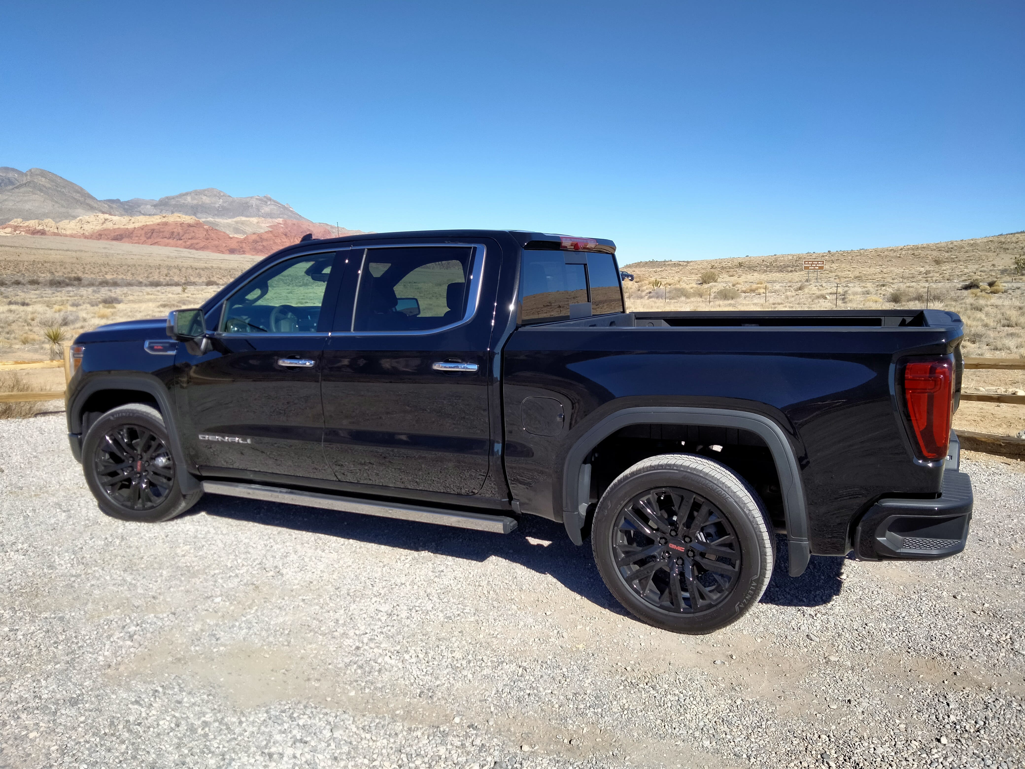 side-view of the 2022 GMC Sierra Denali, black.