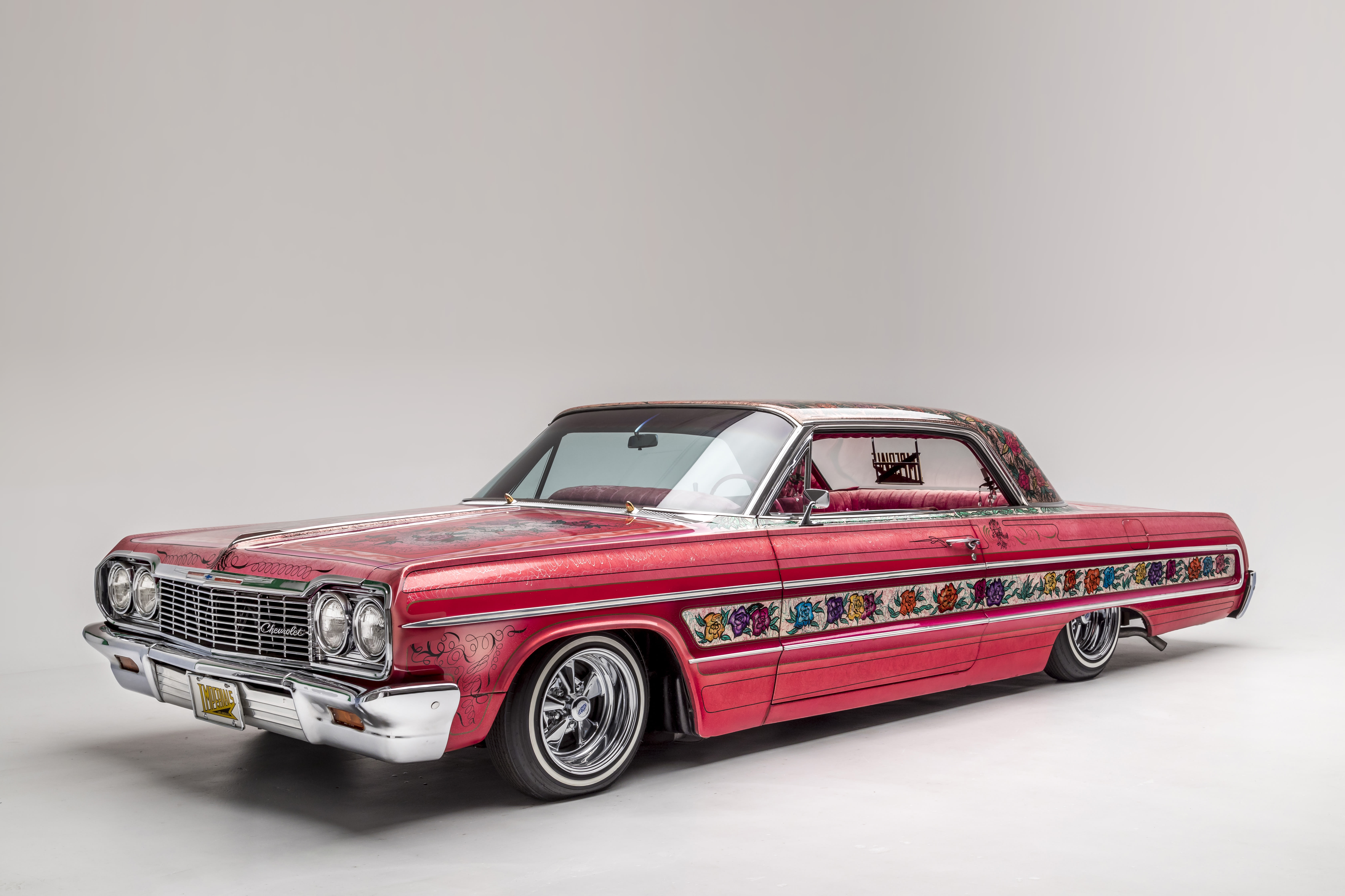 A dark pink custom Chevrolet 1964 Impala, named Gypsy Rose