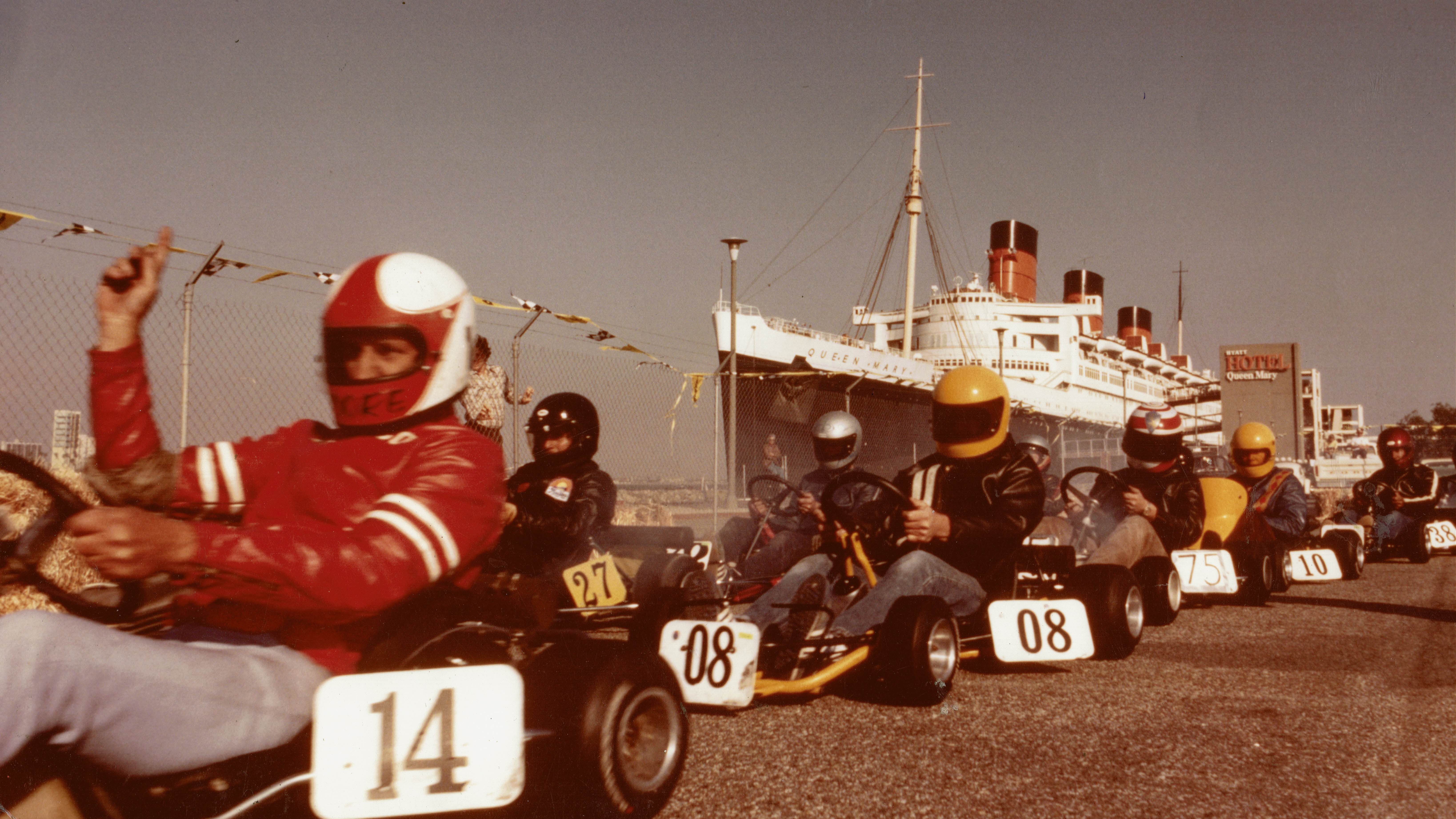 gokarts lined up to race in the parking lot next to the Queen Mary in Long Beach.