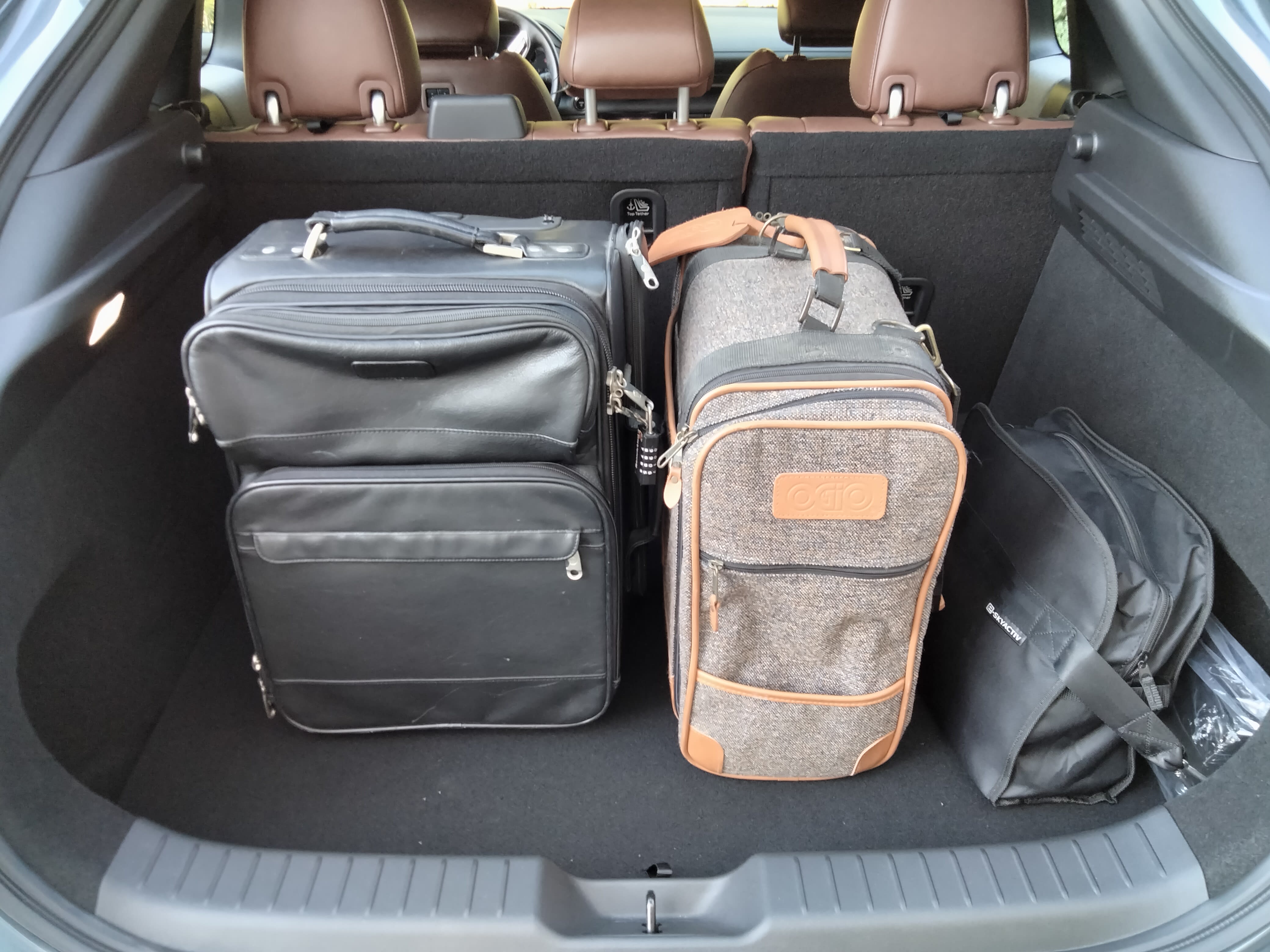 Mazda MX-30 with luggage in the trunk compartment.