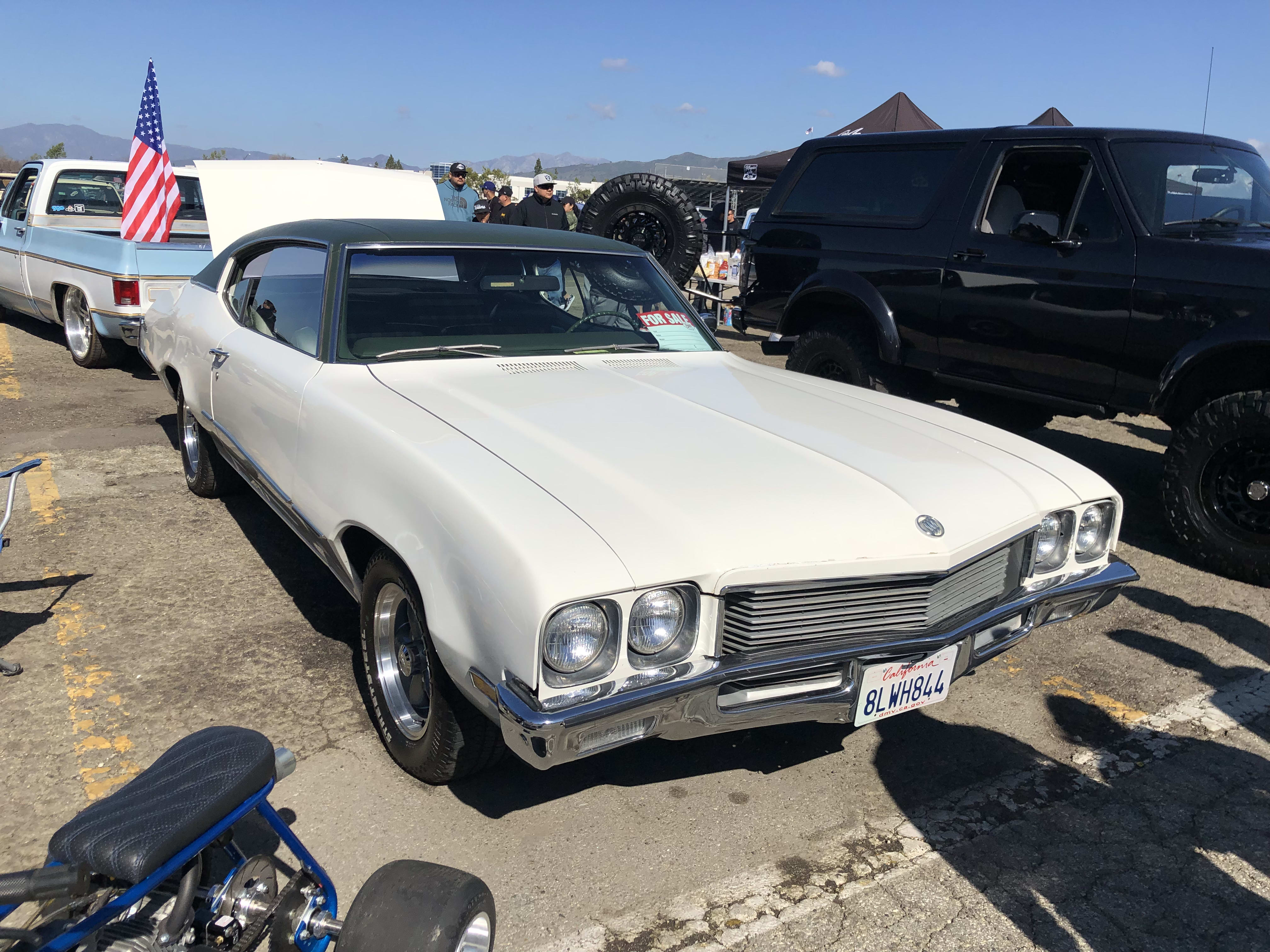 a white classic car, at the Pomona Auto Swap Meet