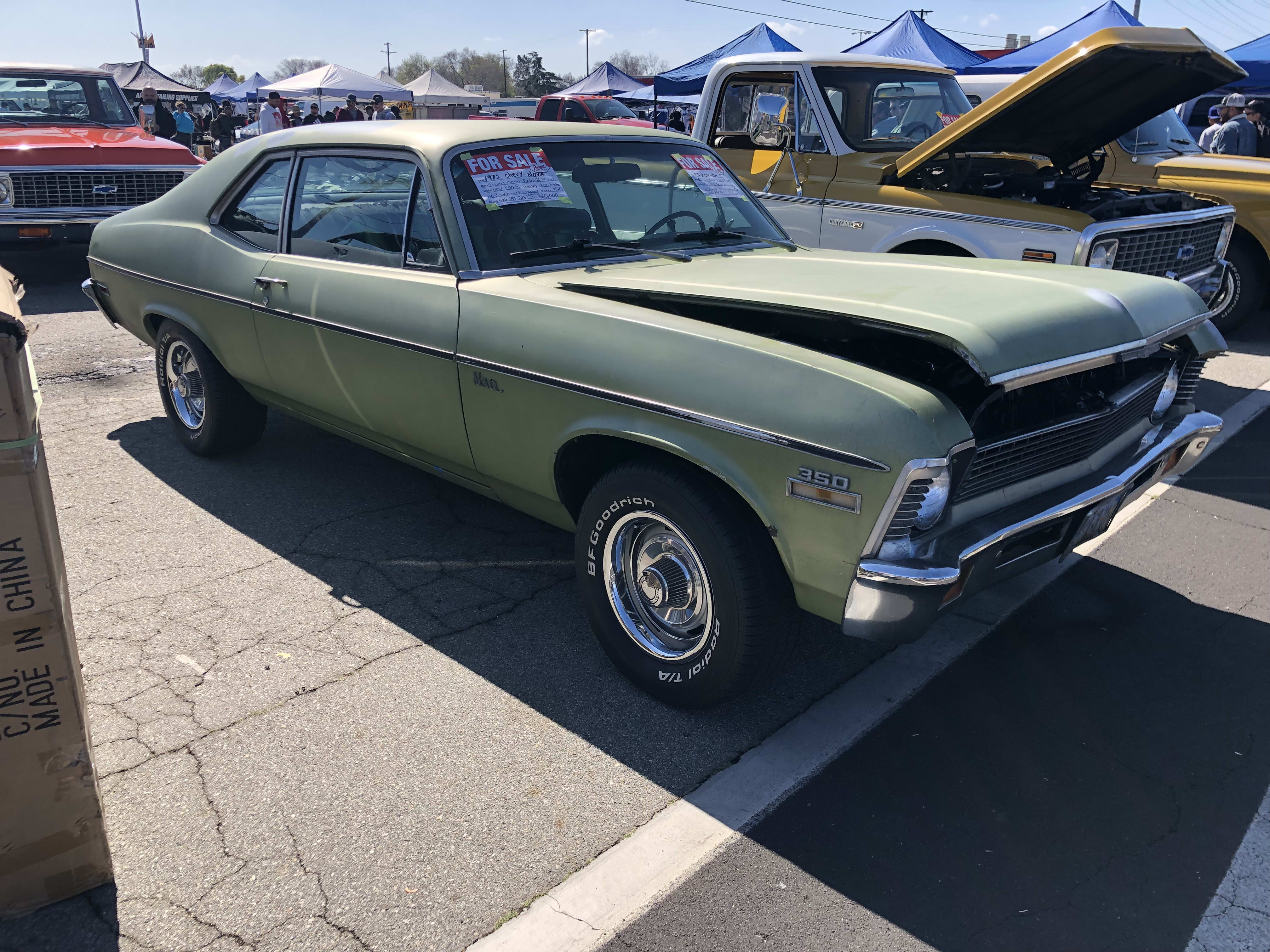 a faded green classic car on display at the Pomona Auto Swapmeet
