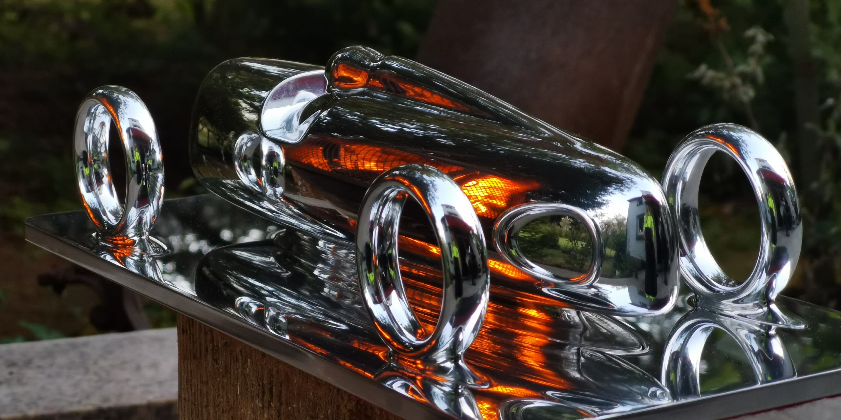 Etrick Art's sculpture, shown outside on a classic table stand.