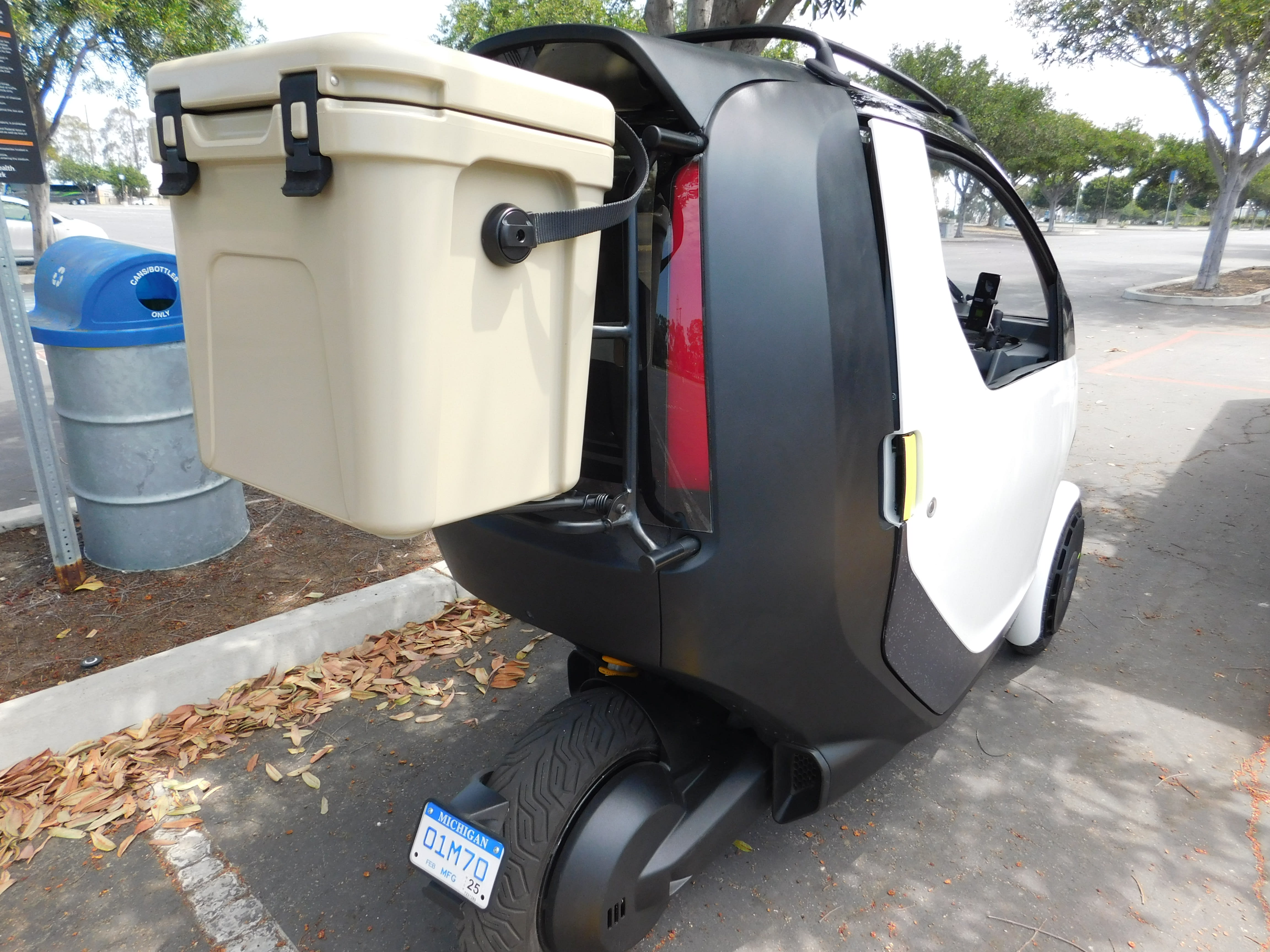image of the Nimbus One EV with an Igloo cooler hanging on the back of it.