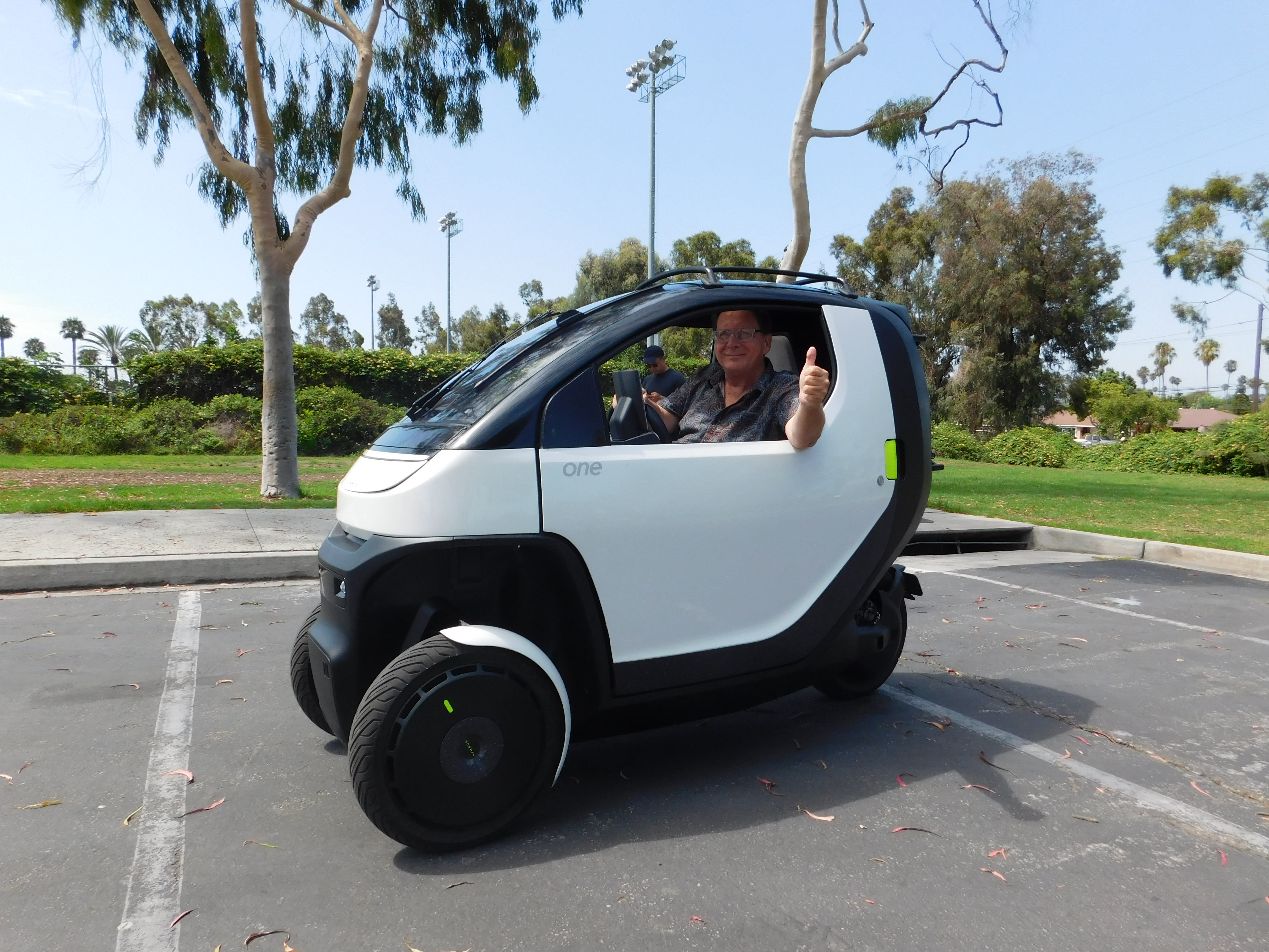 contributor Reed Berry showing a thumbs up sign while sitting in the Nimbus One EV.