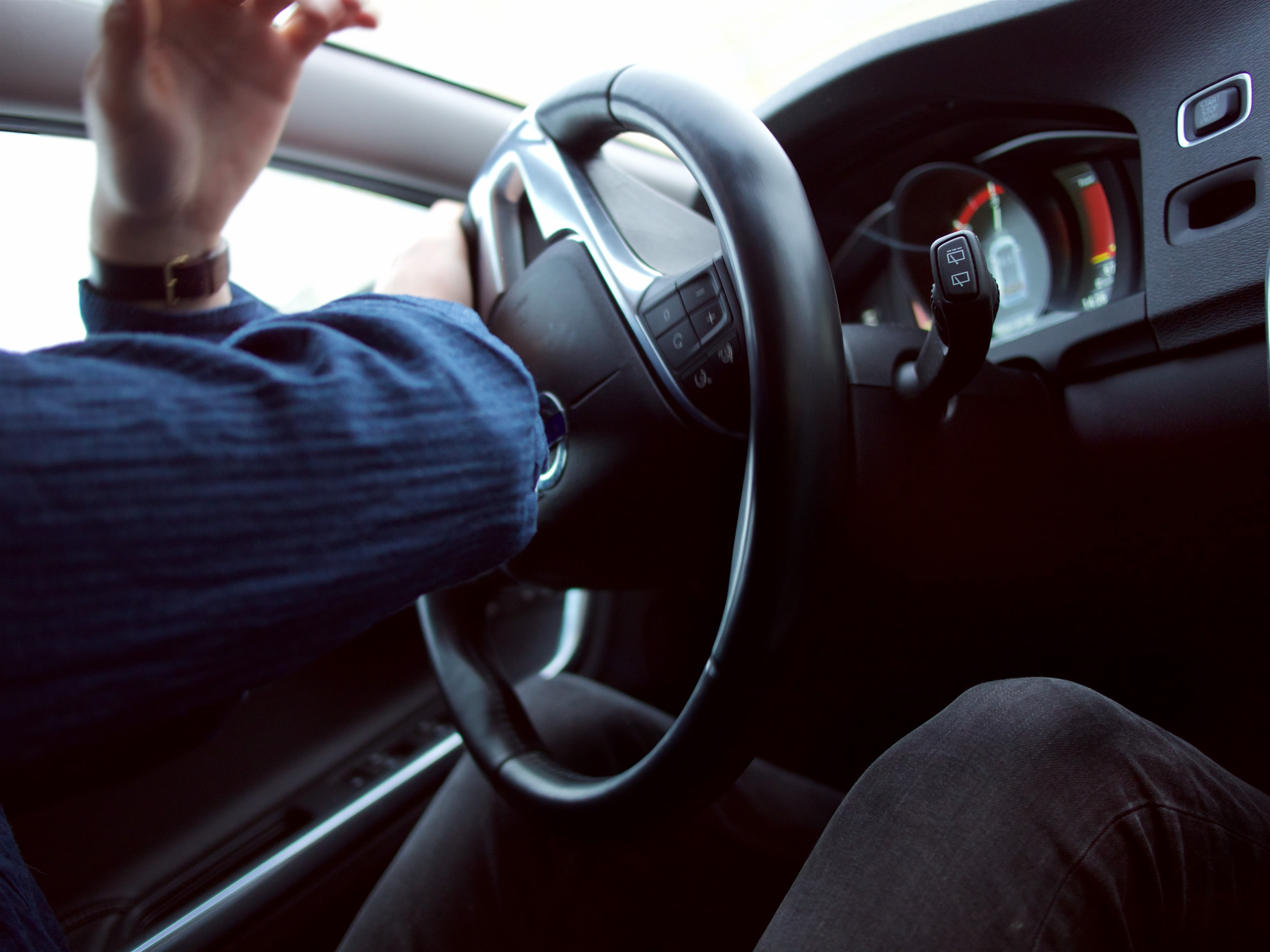 man violently turning the steering wheel