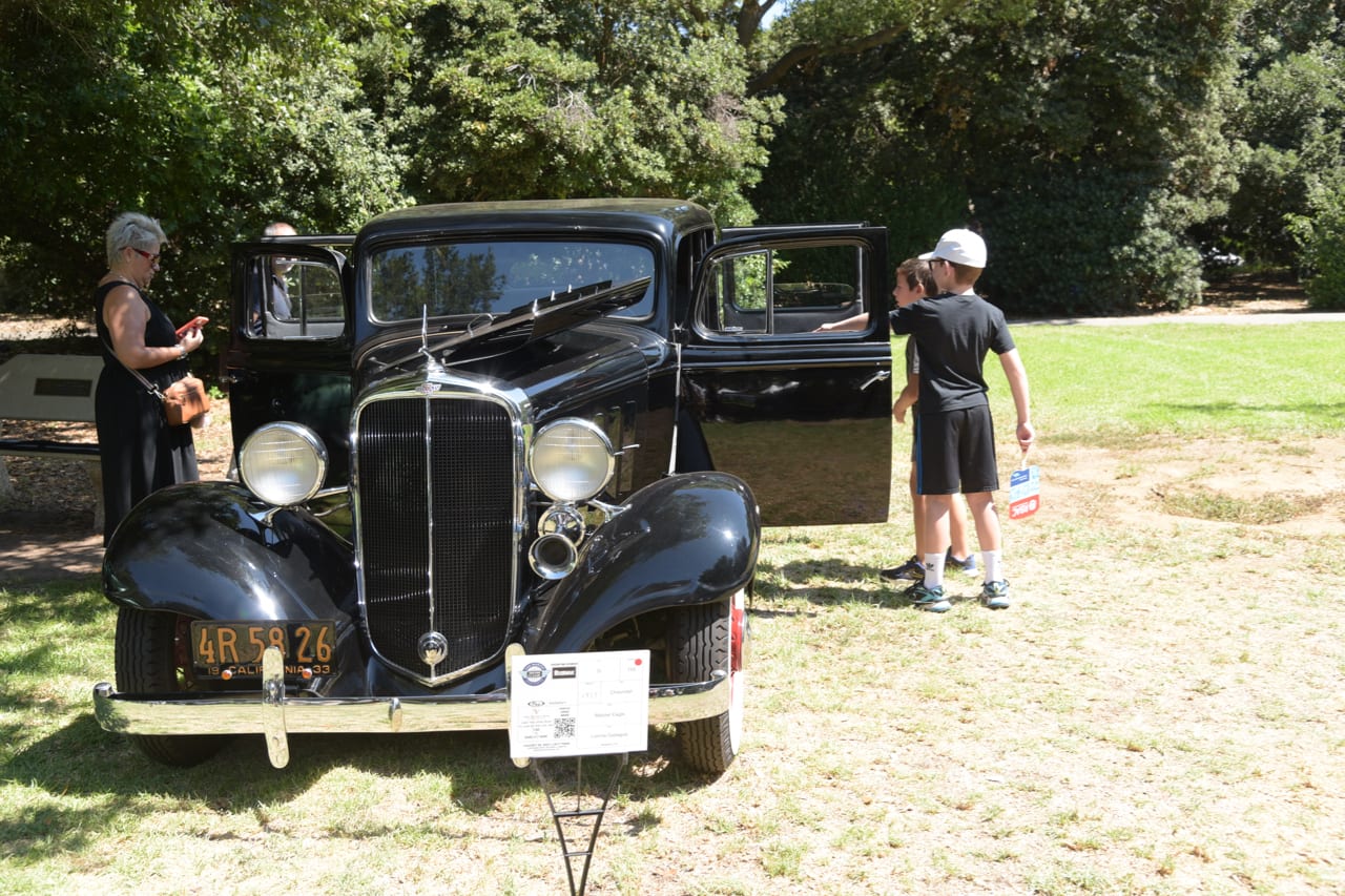 a black classic car on display at the 2022 San Marino Motor Classic at Lacy Park