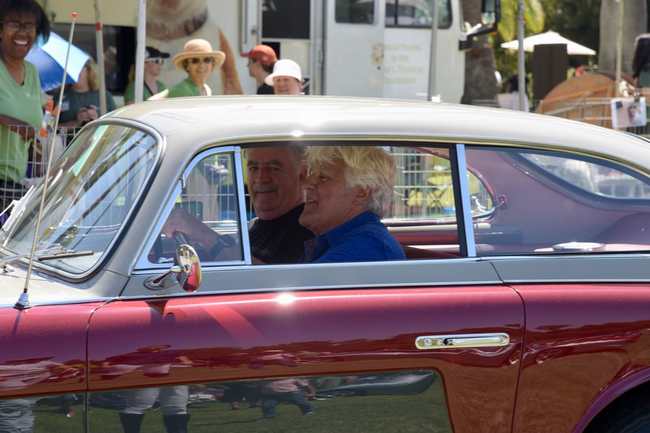 Jay Leno in a red classic car seen at the 2022 San Marino Motor Classic