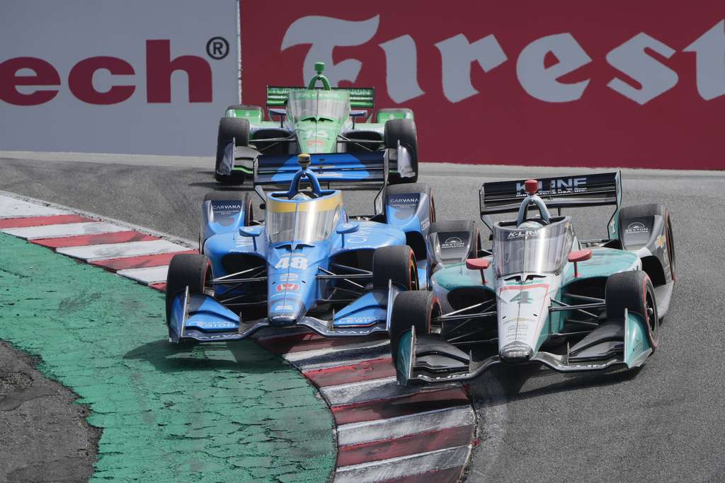 Johnson and Dalton Kellett in a turn, Johnson is up on the curbing as they take that corner.